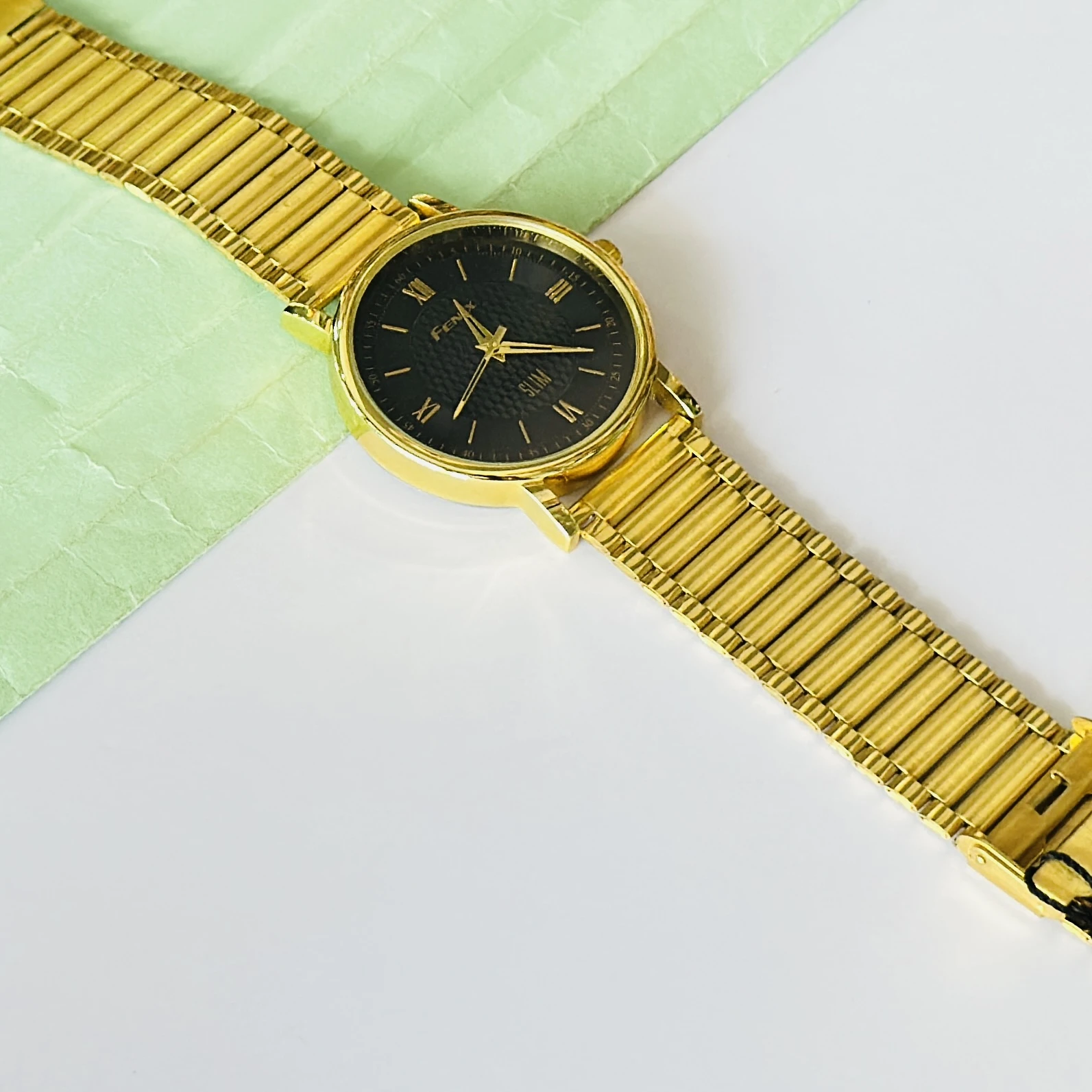 Gold coloured analogue watch