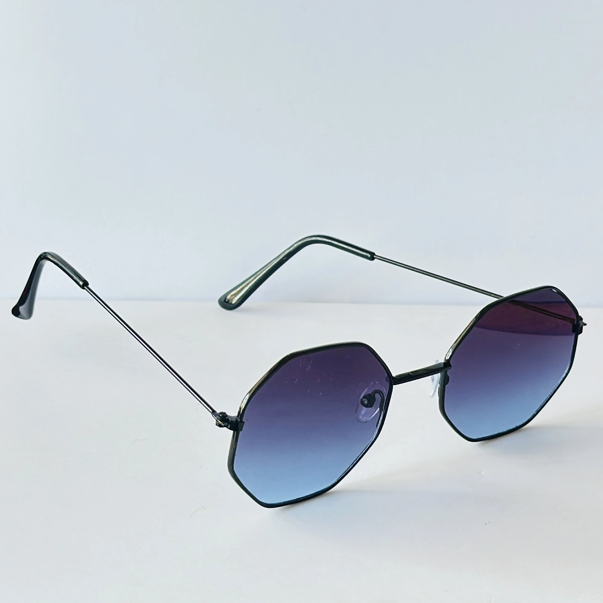 sunglasses appear to be similar to Vincent Chase Octagon Metal Frame Sunglasses