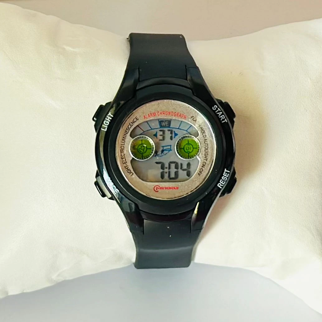 black Mingrui digital sports watch with a plastic or rubber strap.
