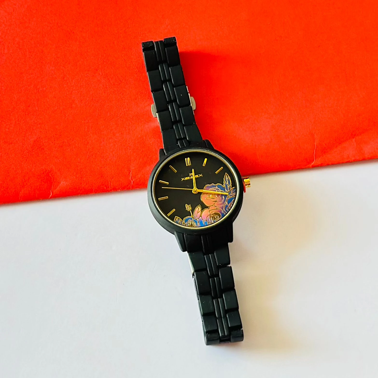 black metal analogue watch with a floral dial design