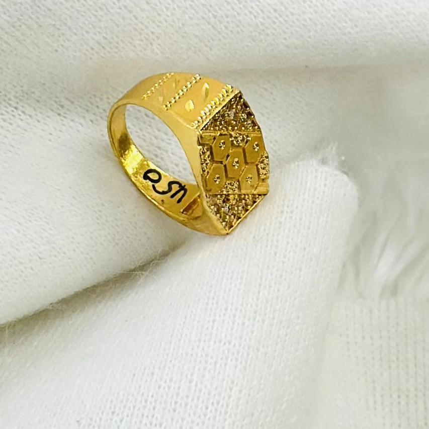 Gold men's ring with a hexagonal design and small white stones.