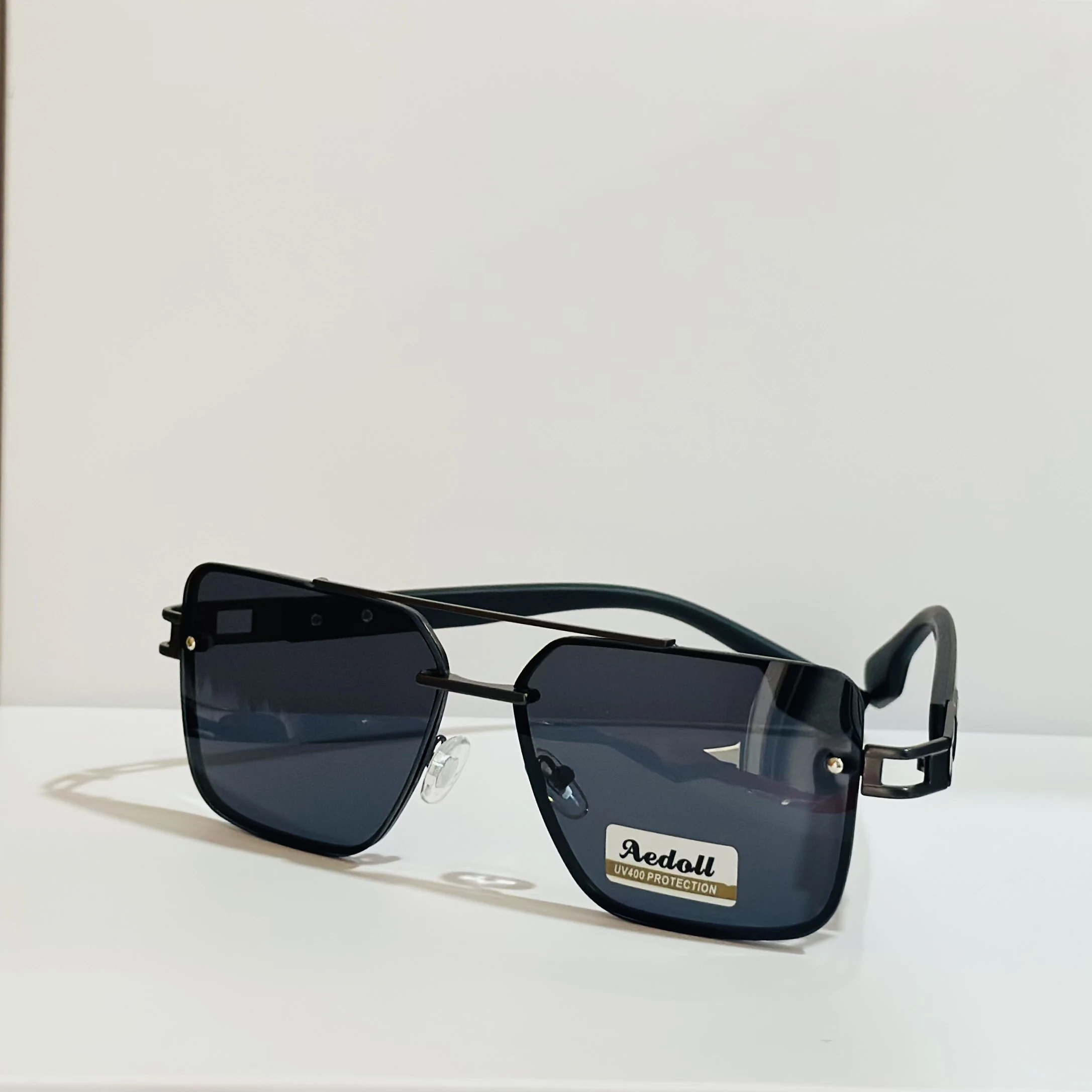 pair of square aviator sunglasses with a black metal frame and gradient lenses.