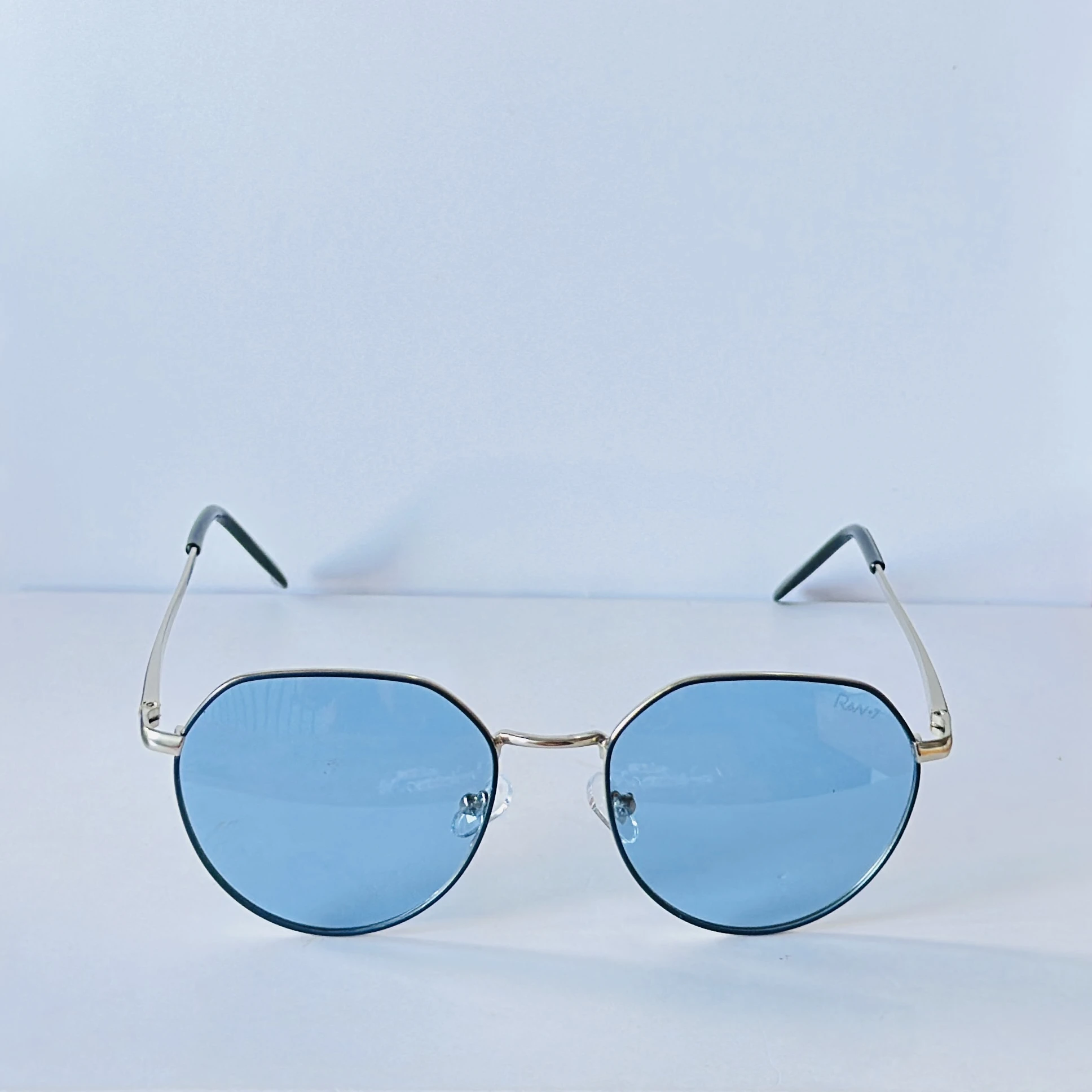 sunglasses appear to be the IRUS S1133 Hexagonal model with a silver frame and blue lenses.