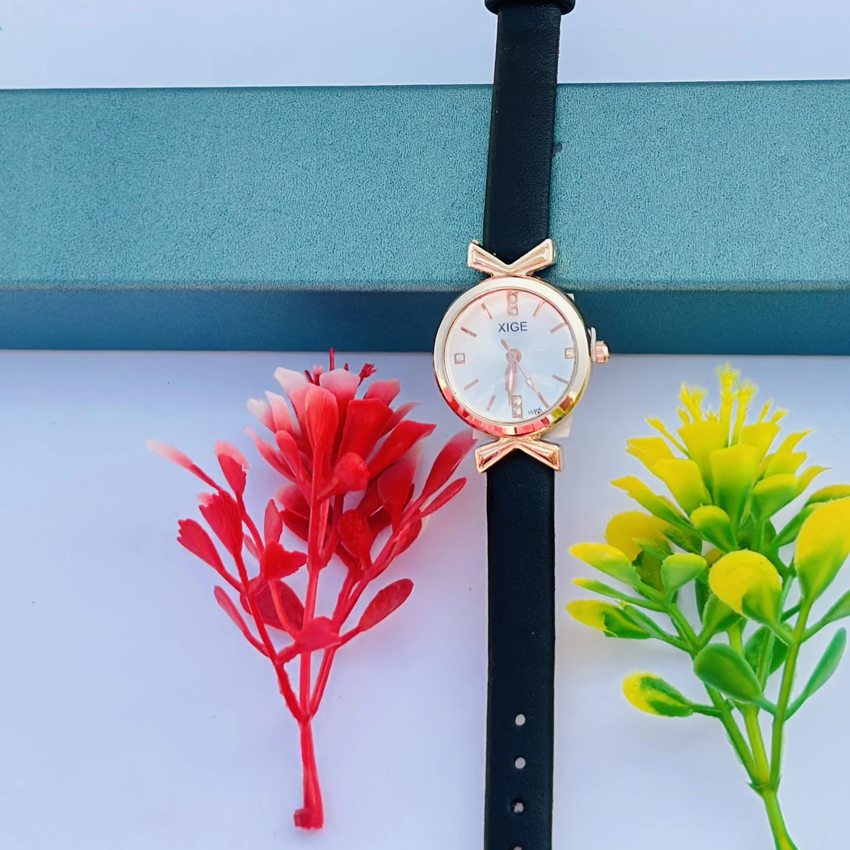 Women’s classic simple leather analog quartz wrist watch with a black strap and rose gold case.