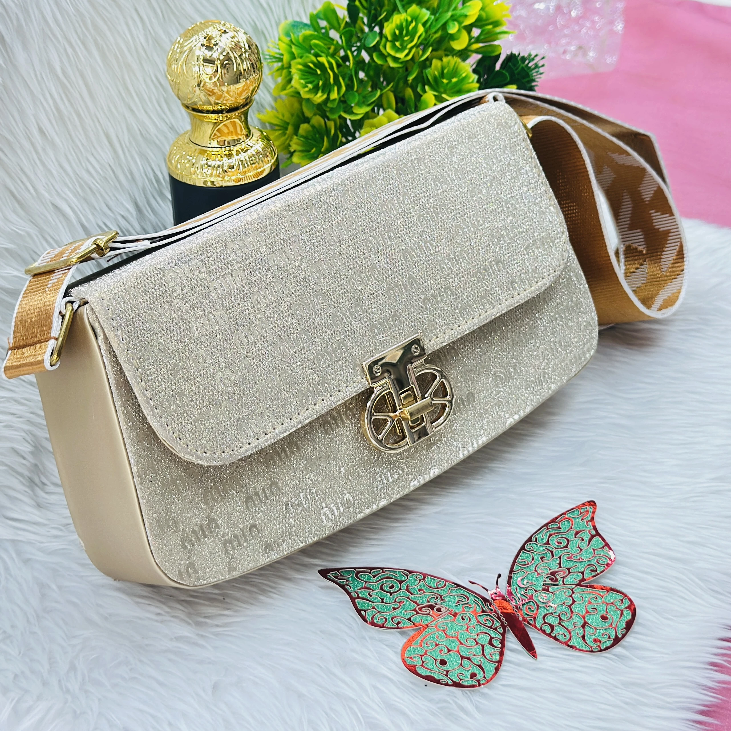 Gold colored, glittery structured handbag