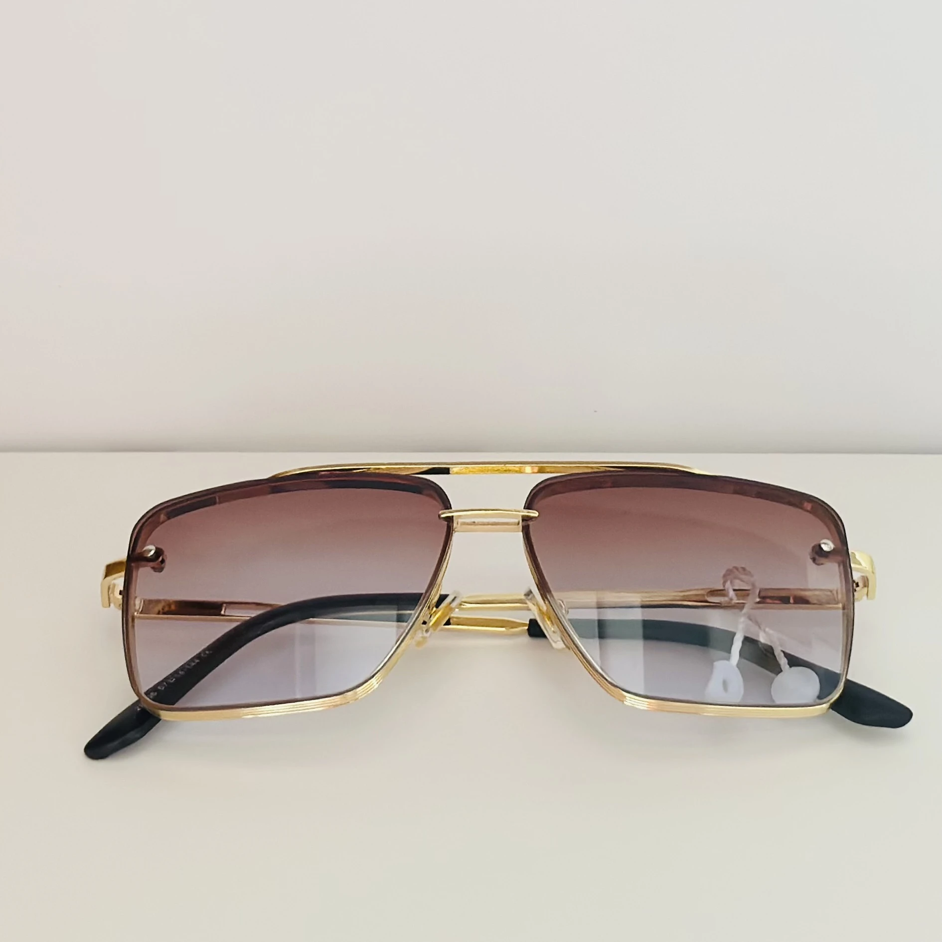 pair of DITA Mach-Six sunglasses with gold-tone frames and brown-to-clear gradient lenses