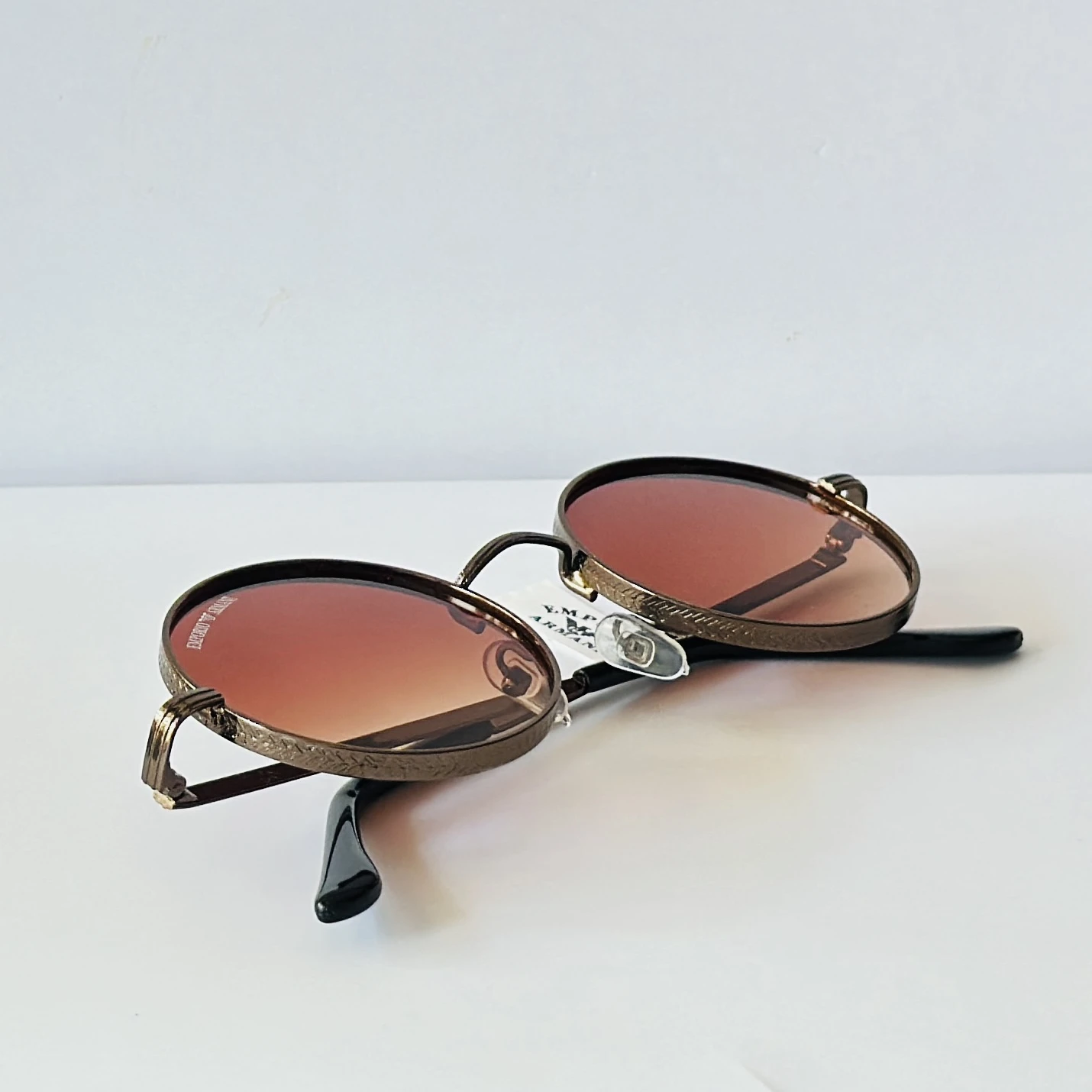 sunglasses are Emporio Armani round-frame