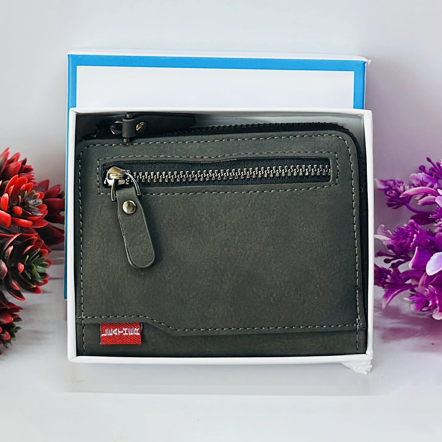 compact men's wallet with a secure zip closure, made from vegan leather.