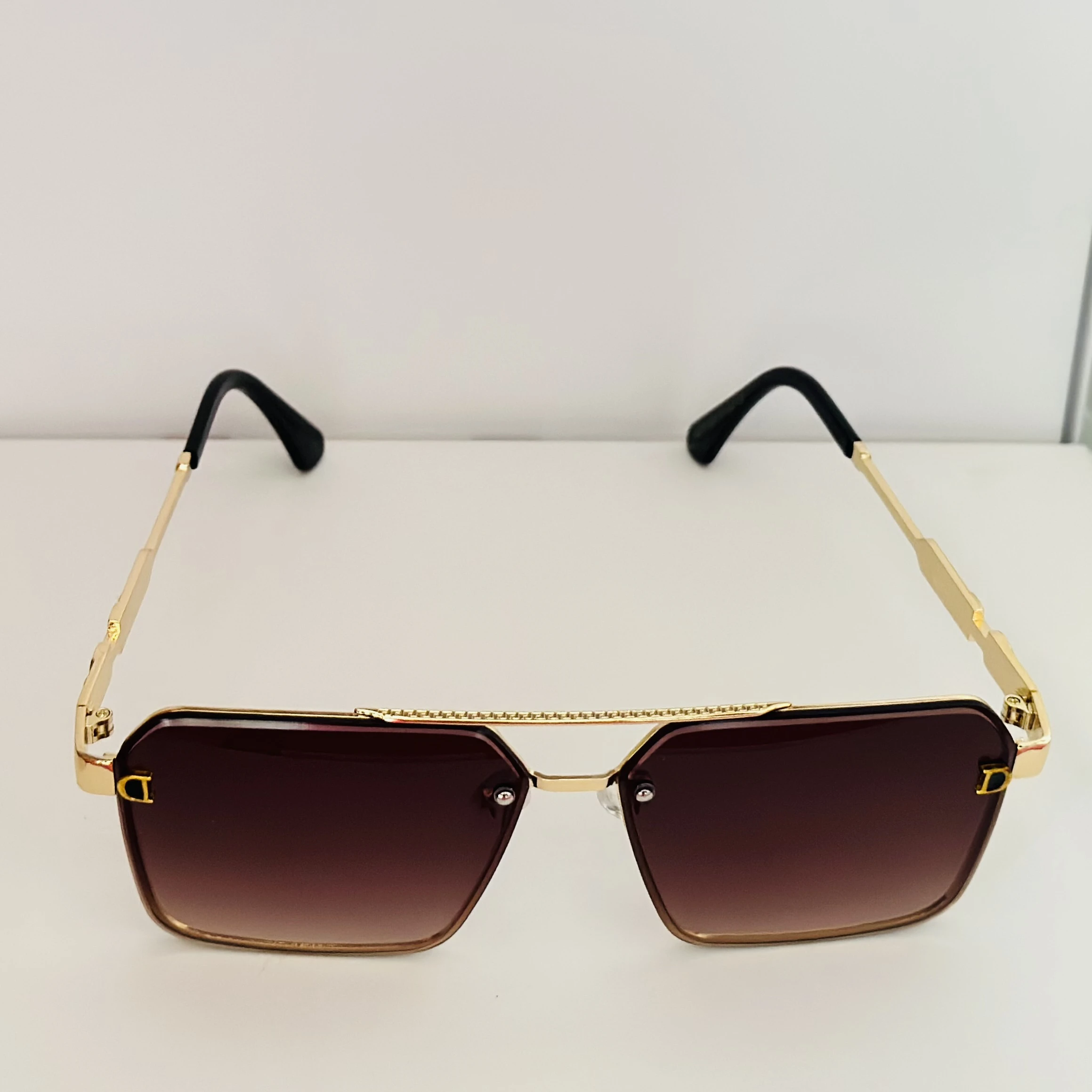 Gold Frame brown gradient lens oversized square sunglasses with black temple arms.