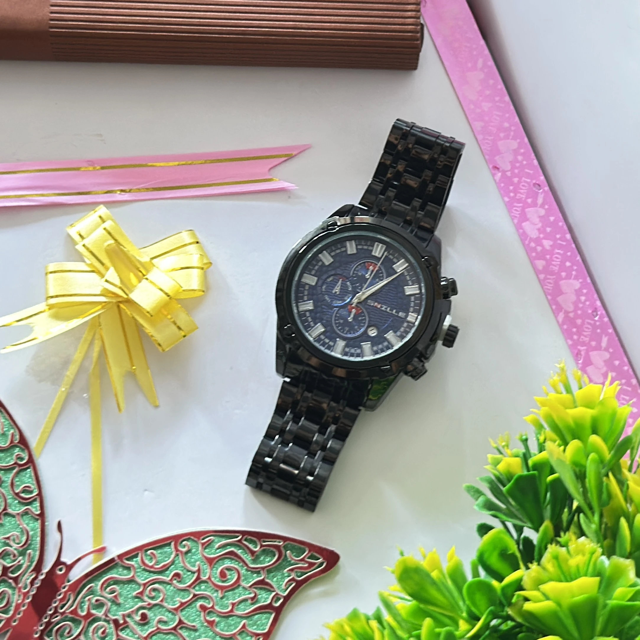 Snille brand wristwatch features a black analog