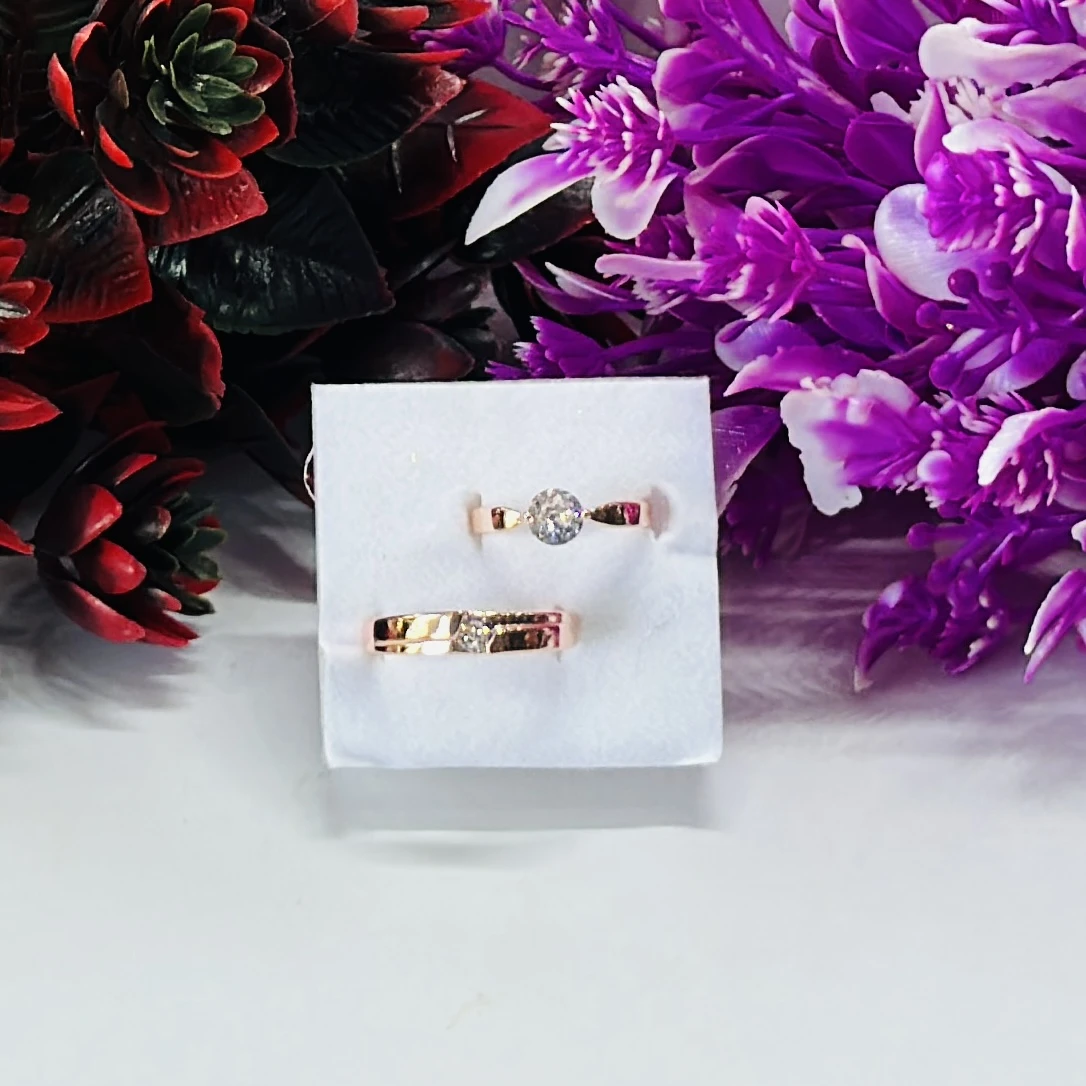 Rose gold-plated cubic zirconia couple rings.