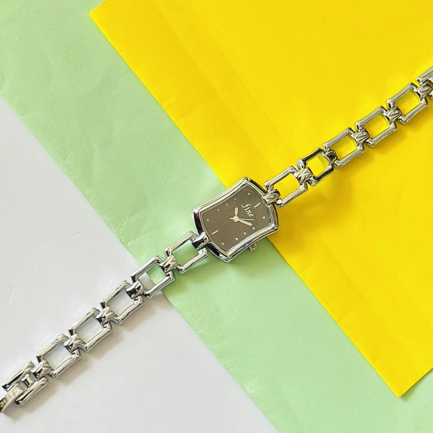 women's analog watch with a silver-tone metal case and a matching link bracelet strap