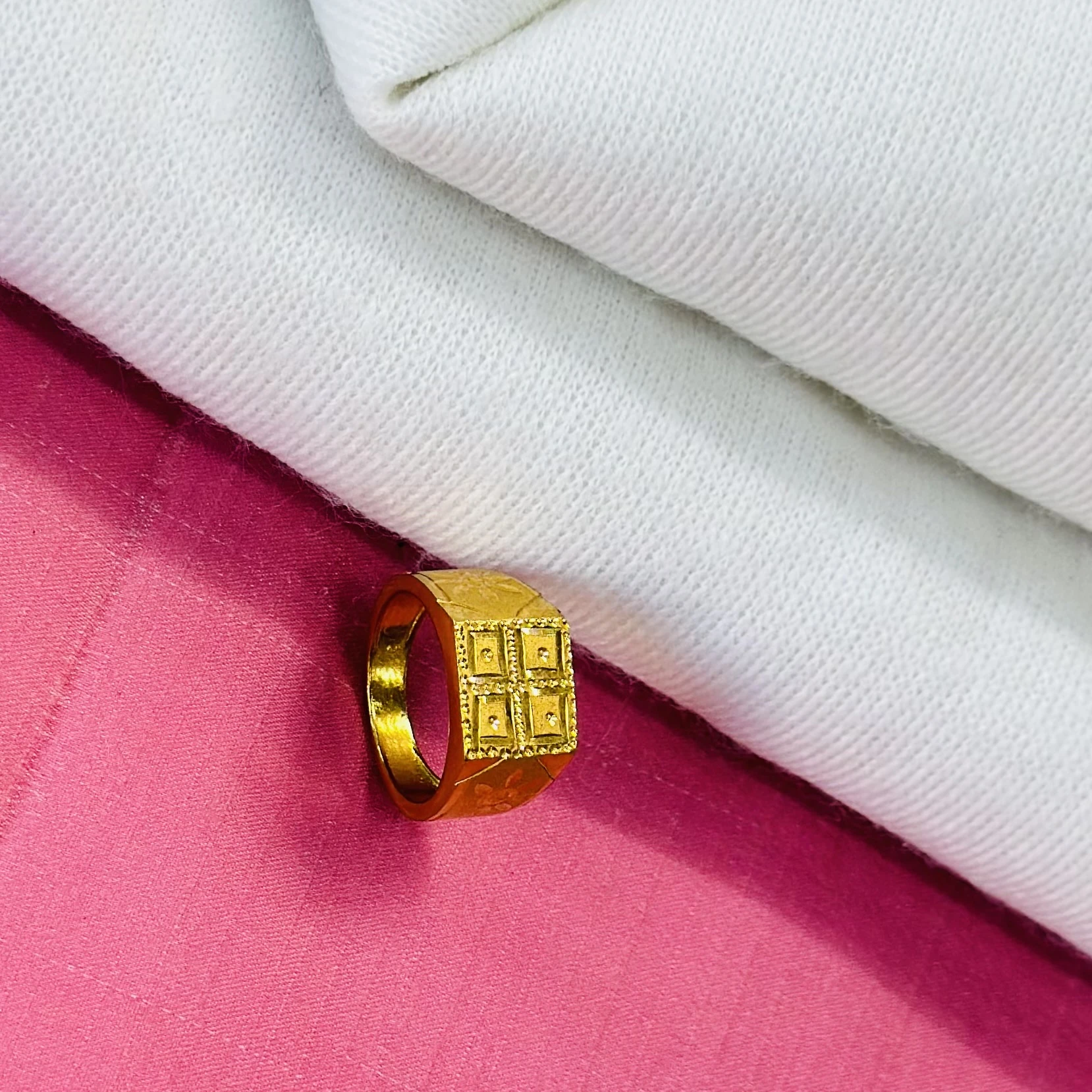 Gold ring for men with a matte finish and detailed square design.
