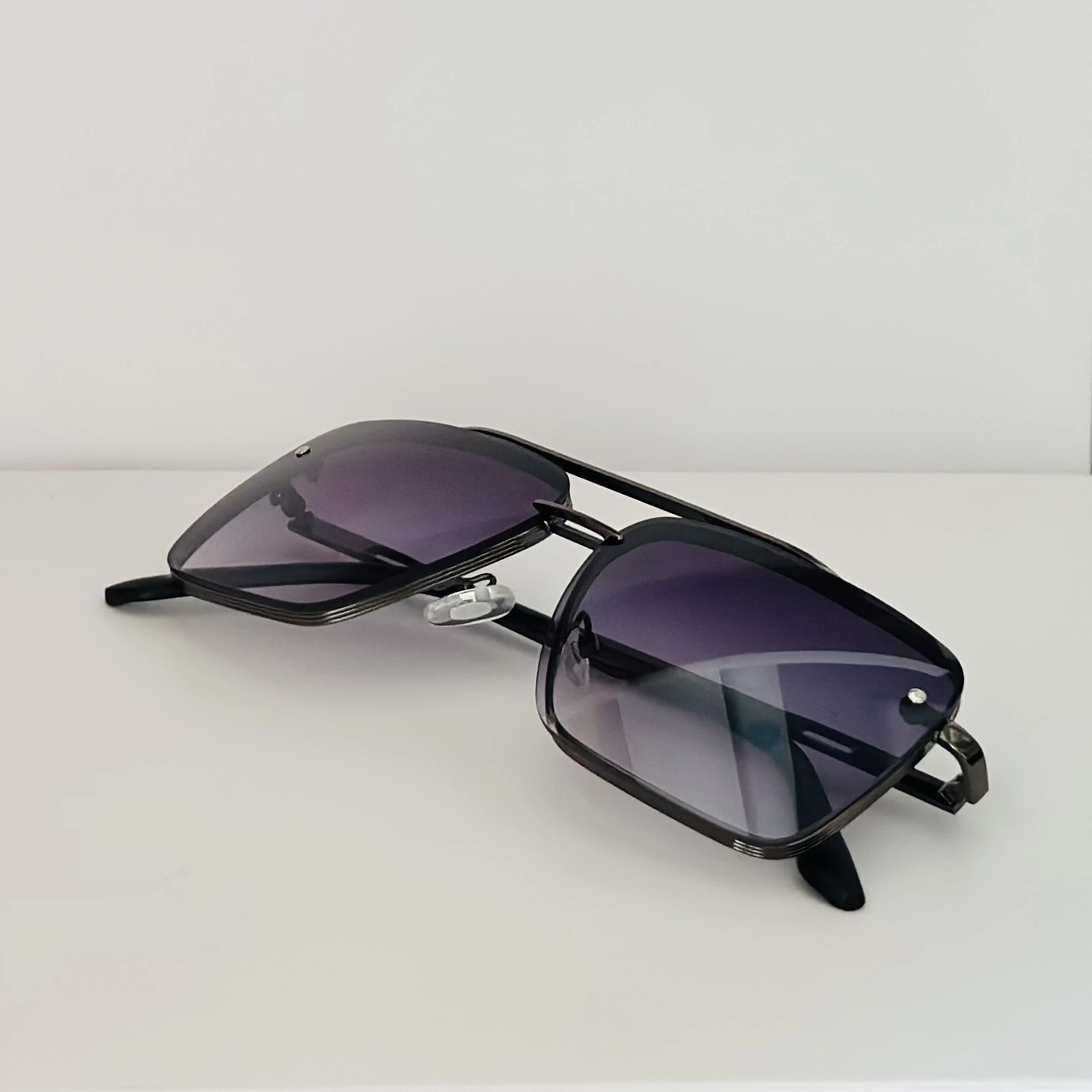 Black metal-framed square sunglasses with gradient lenses.