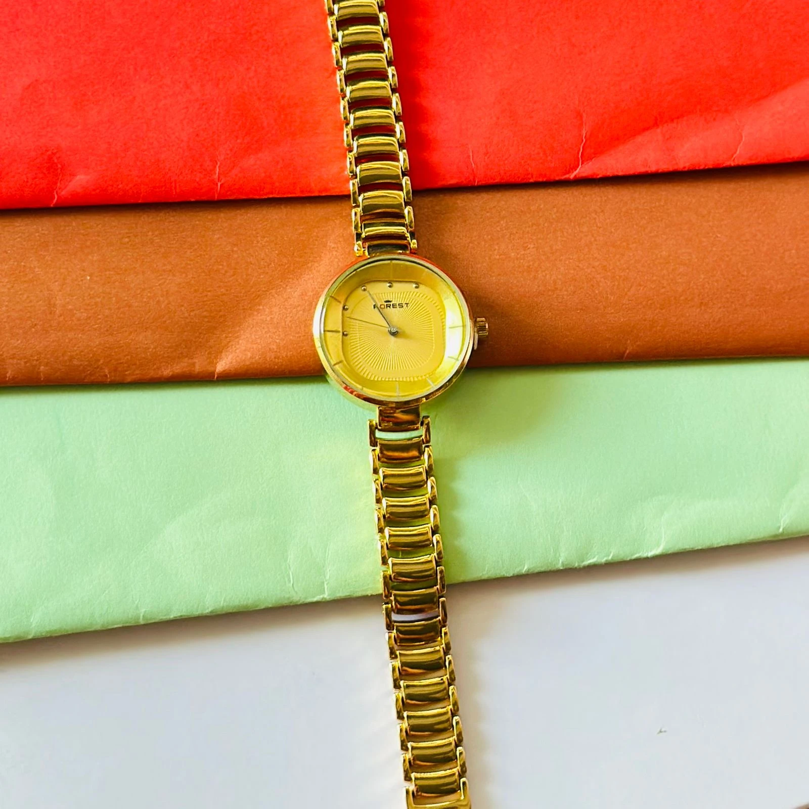 analog watch with a white dial and a rose gold metal strap