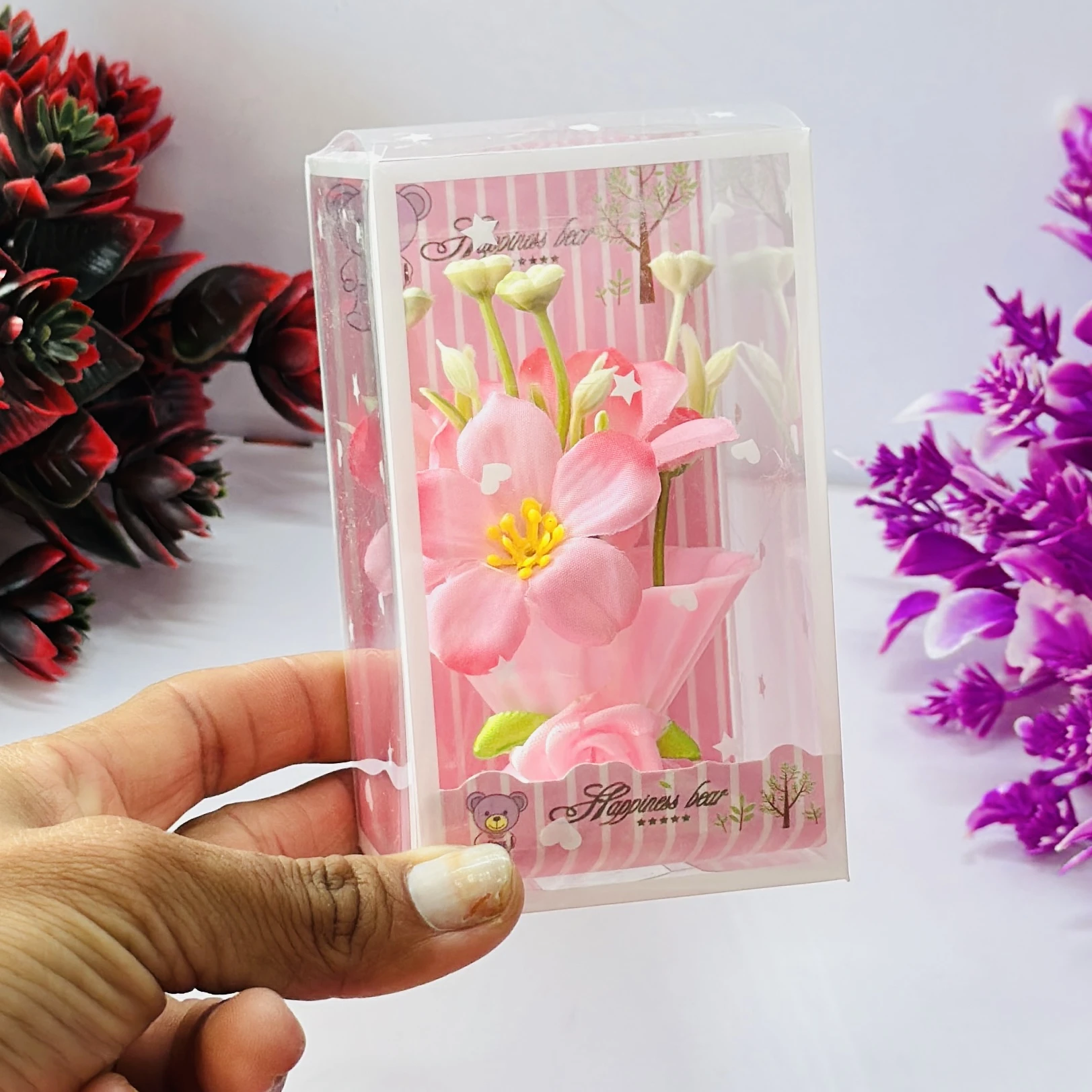 Set of artificial pink tulip flowers presented in a decorative gift box.