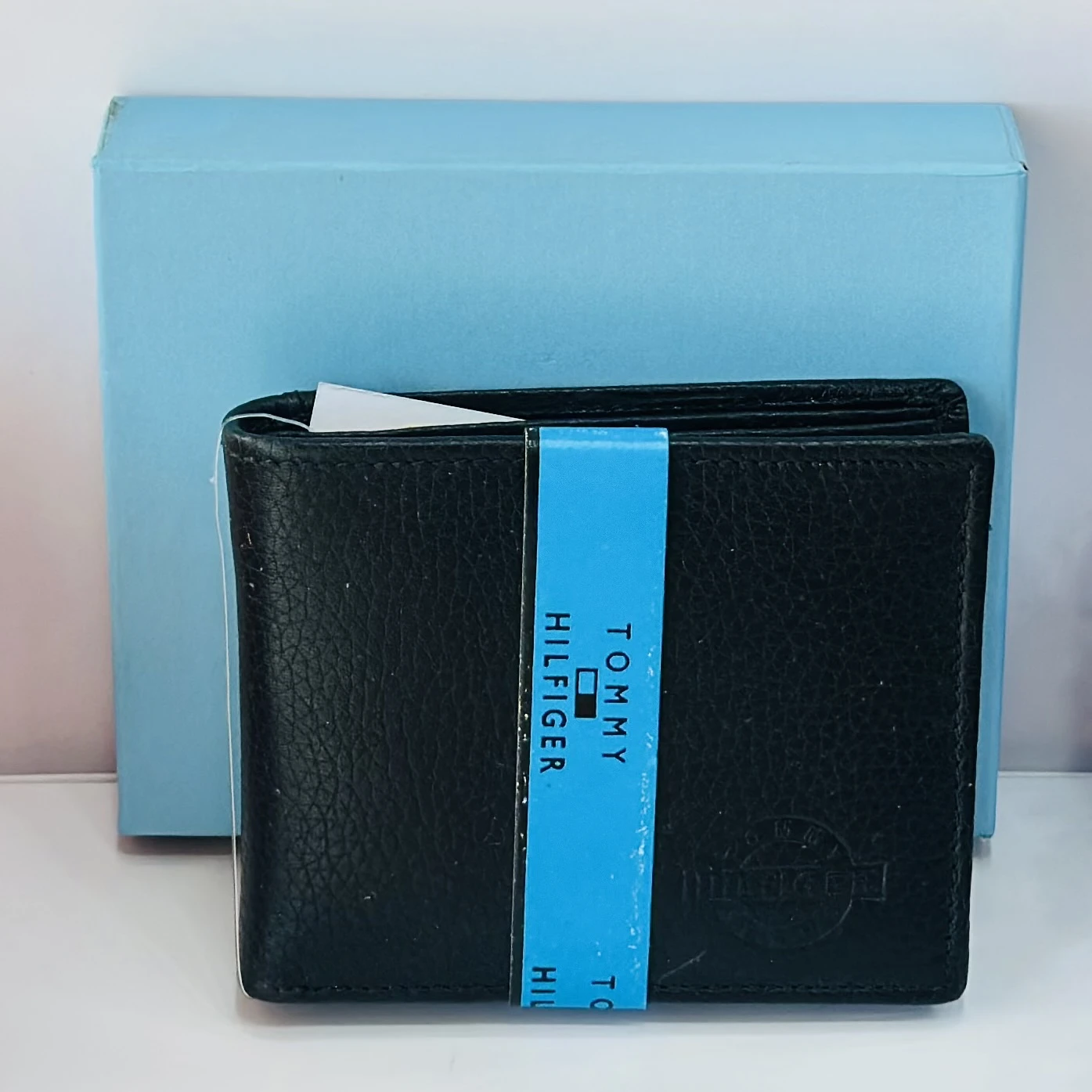 Black Tommy Hilfiger men's genuine leather bi-fold wallet.