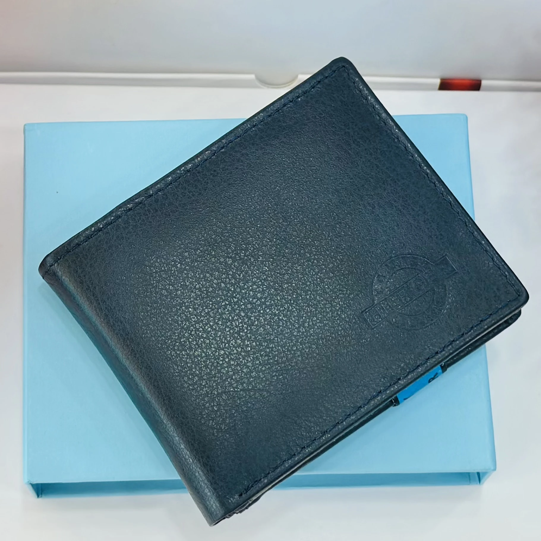 Blue Tommy Hilfiger men's genuine leather bi-fold wallet.