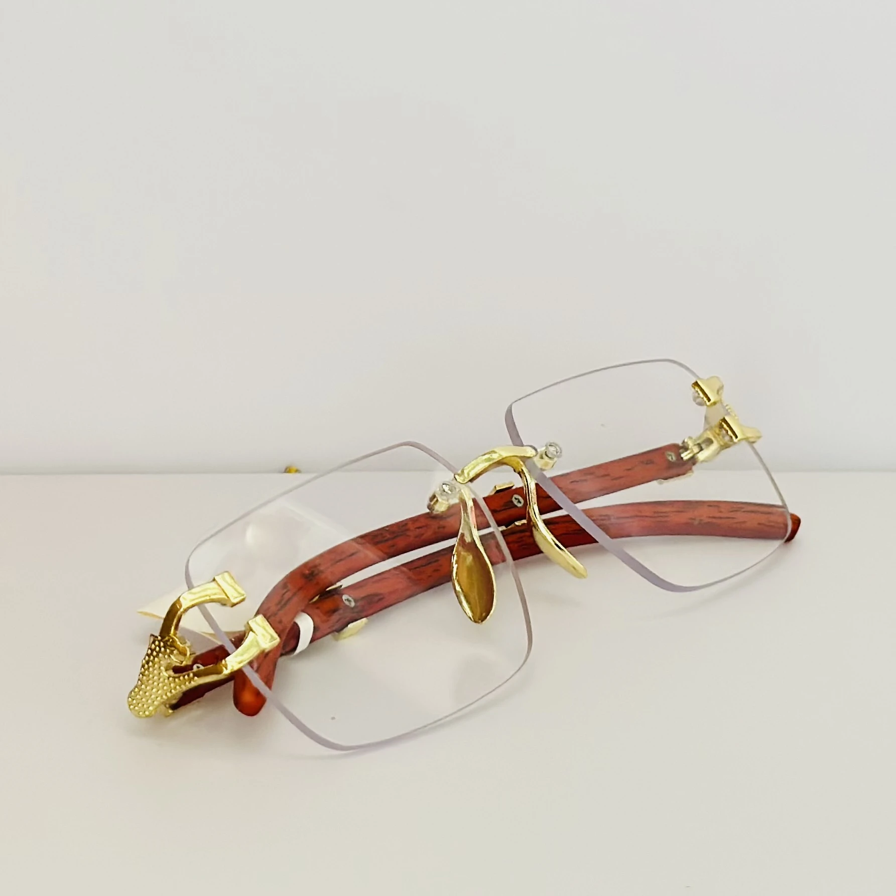 Street Knitted men's rimless gold frame glasses with clear lenses and a woodgrain finish on the arms.