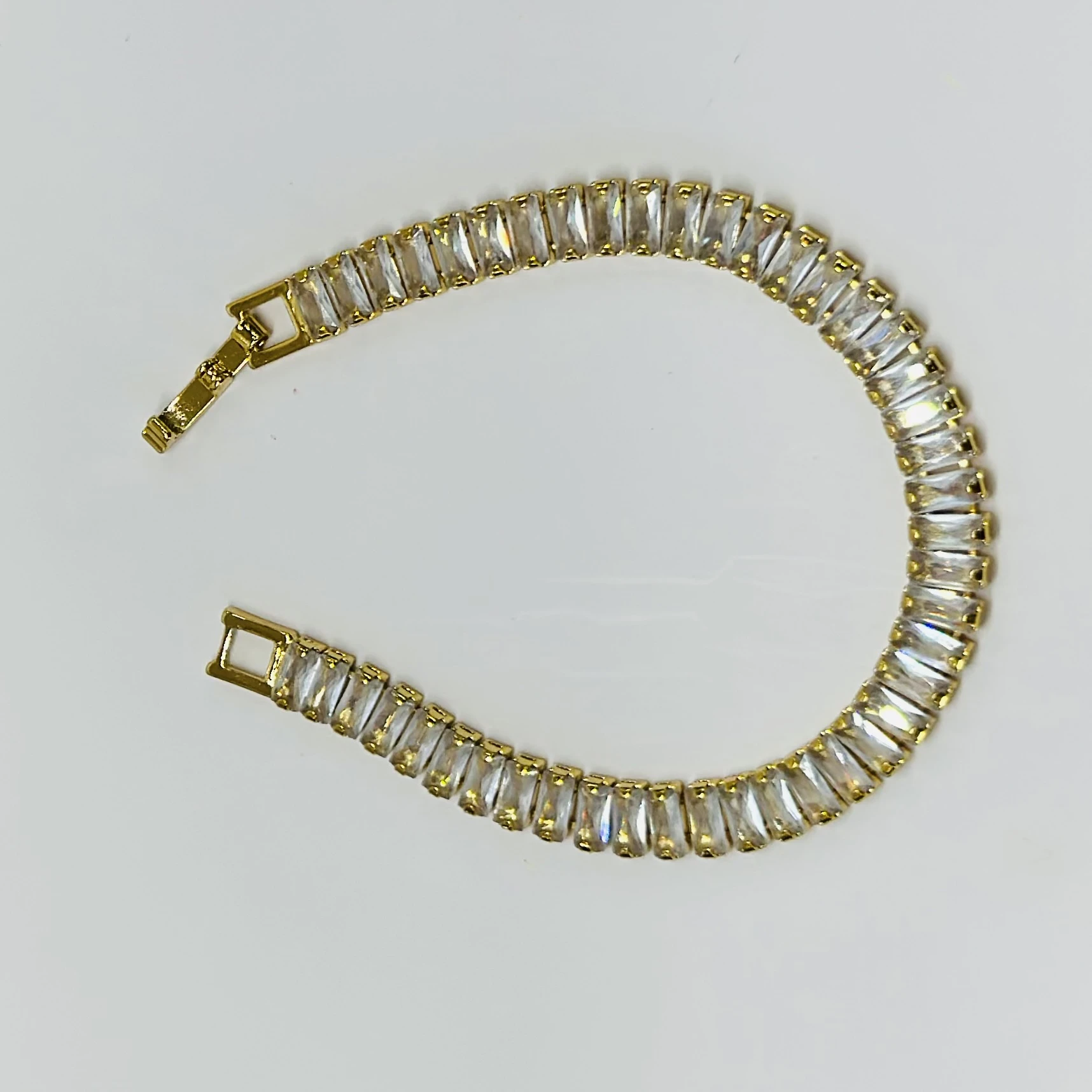 Gold plated black baguette tennis bracelet with artificial stones.