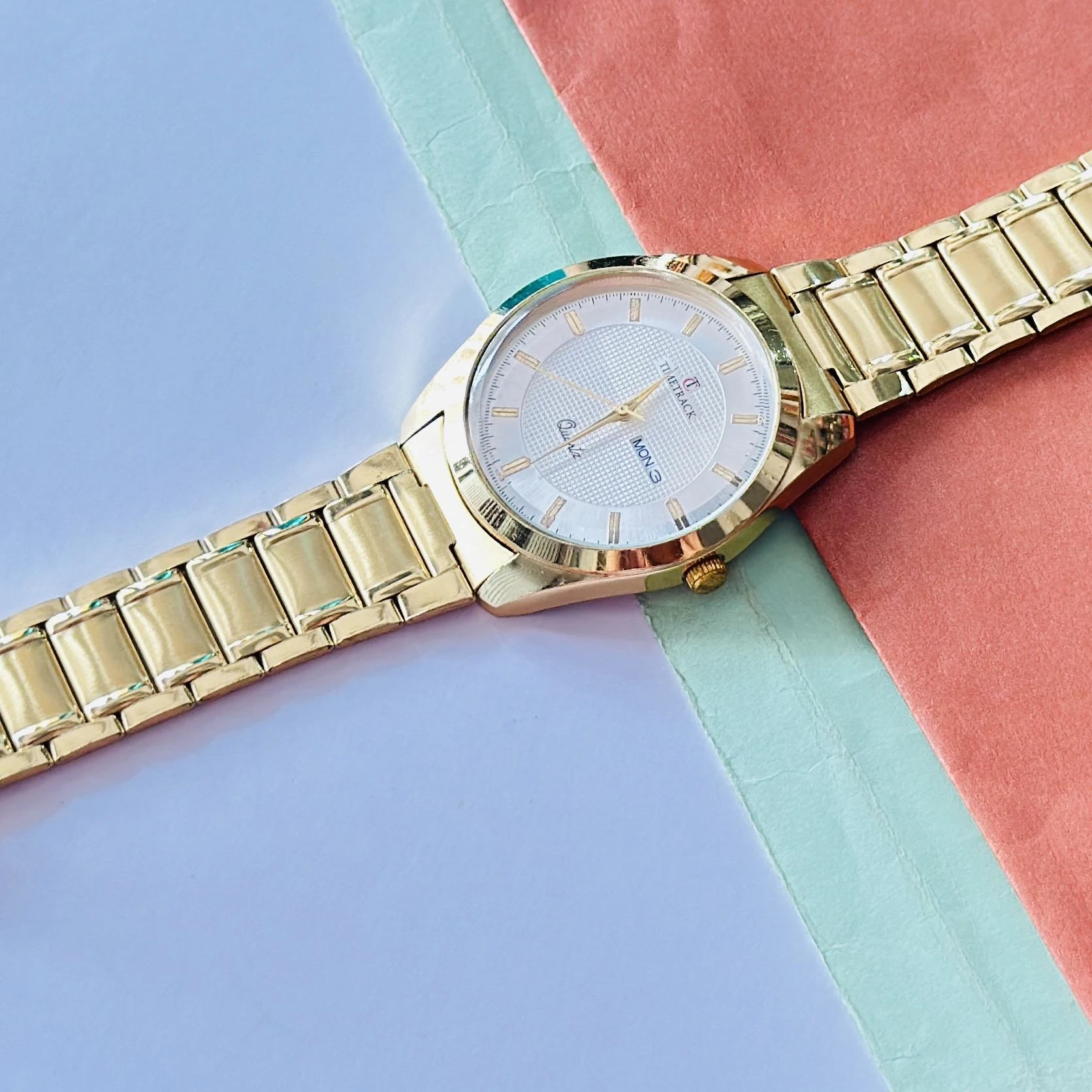 Gold coloured analogue watch