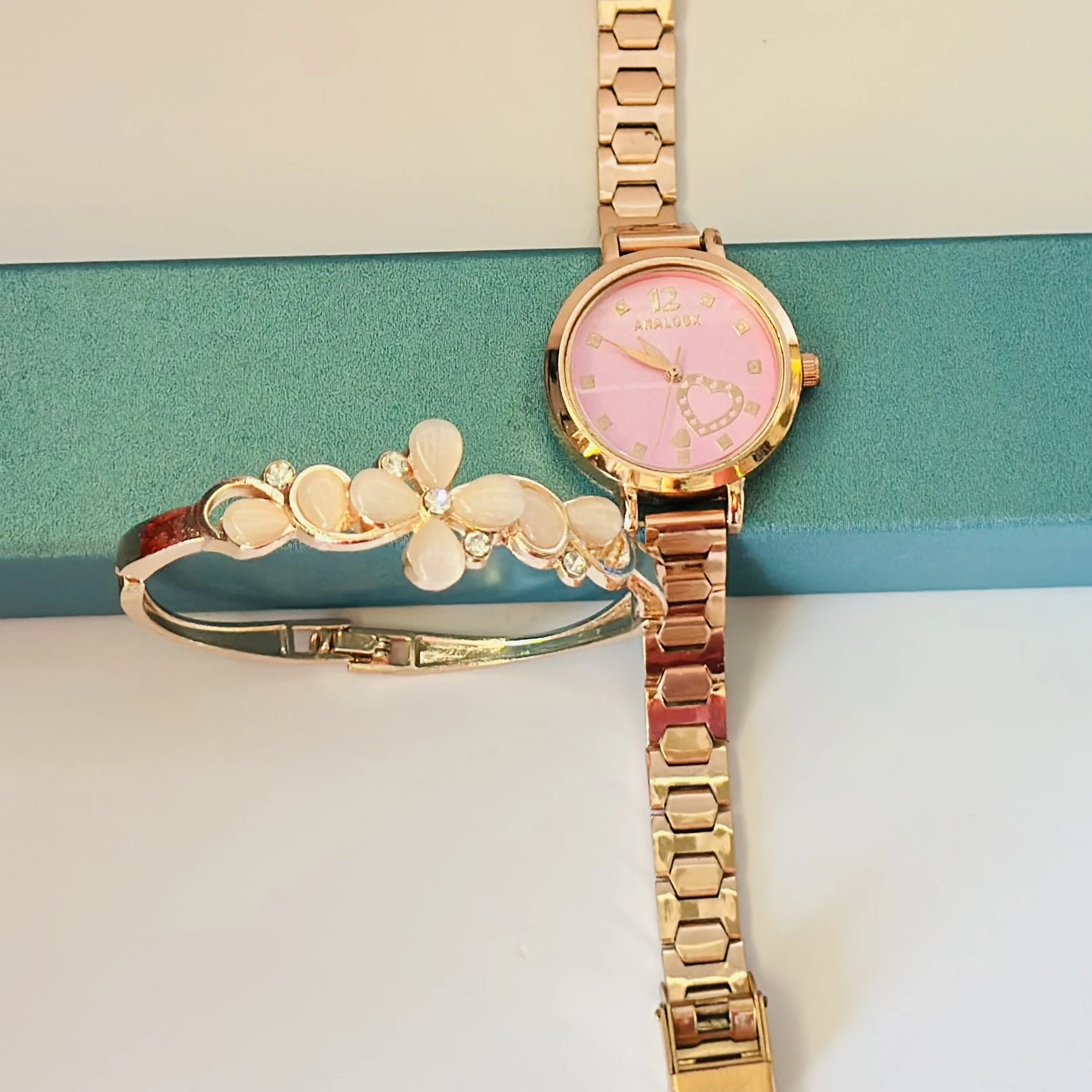 analog watch with a bracelet set combo in rose gold.