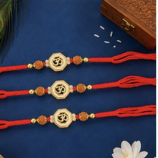 Raksha Bandhan rakhis with gold-plated Om symbols and red threads.