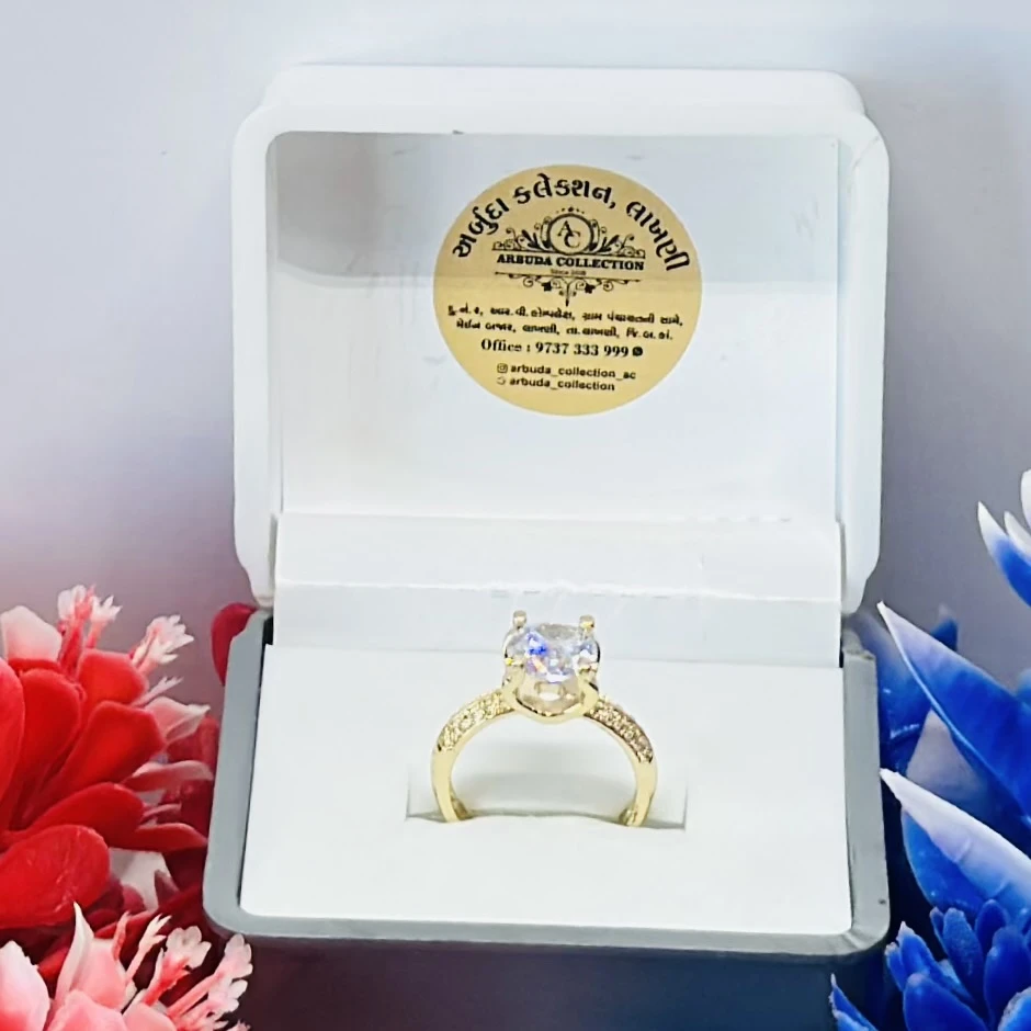 Gold toned ring with a large central clear stone
