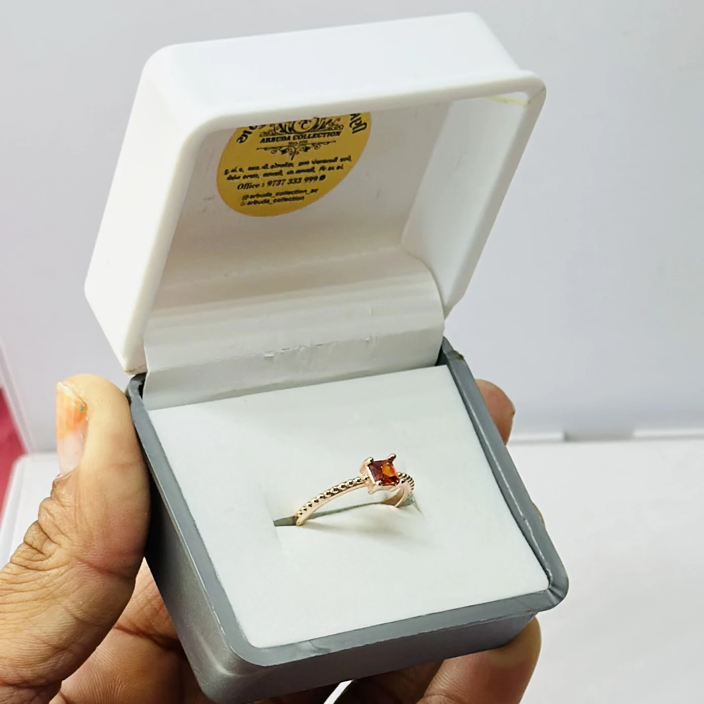 sterling silver ring with a rectangular orange gemstone, possibly hessonite garnet or citrine.