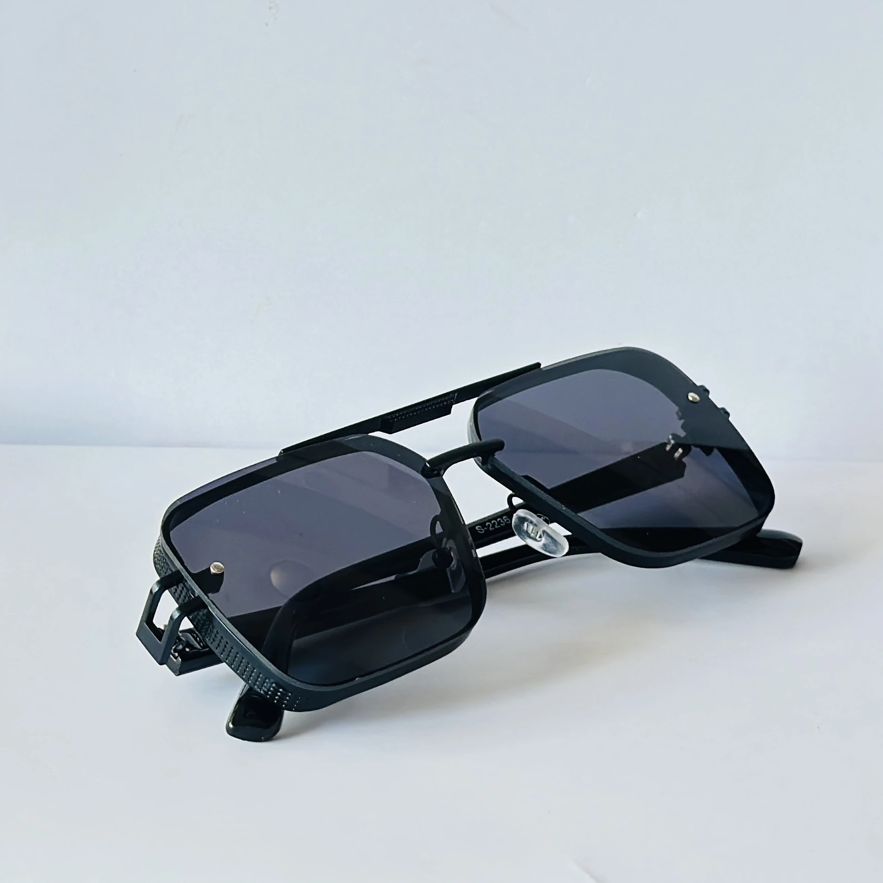Black sunglasses feature a square frame