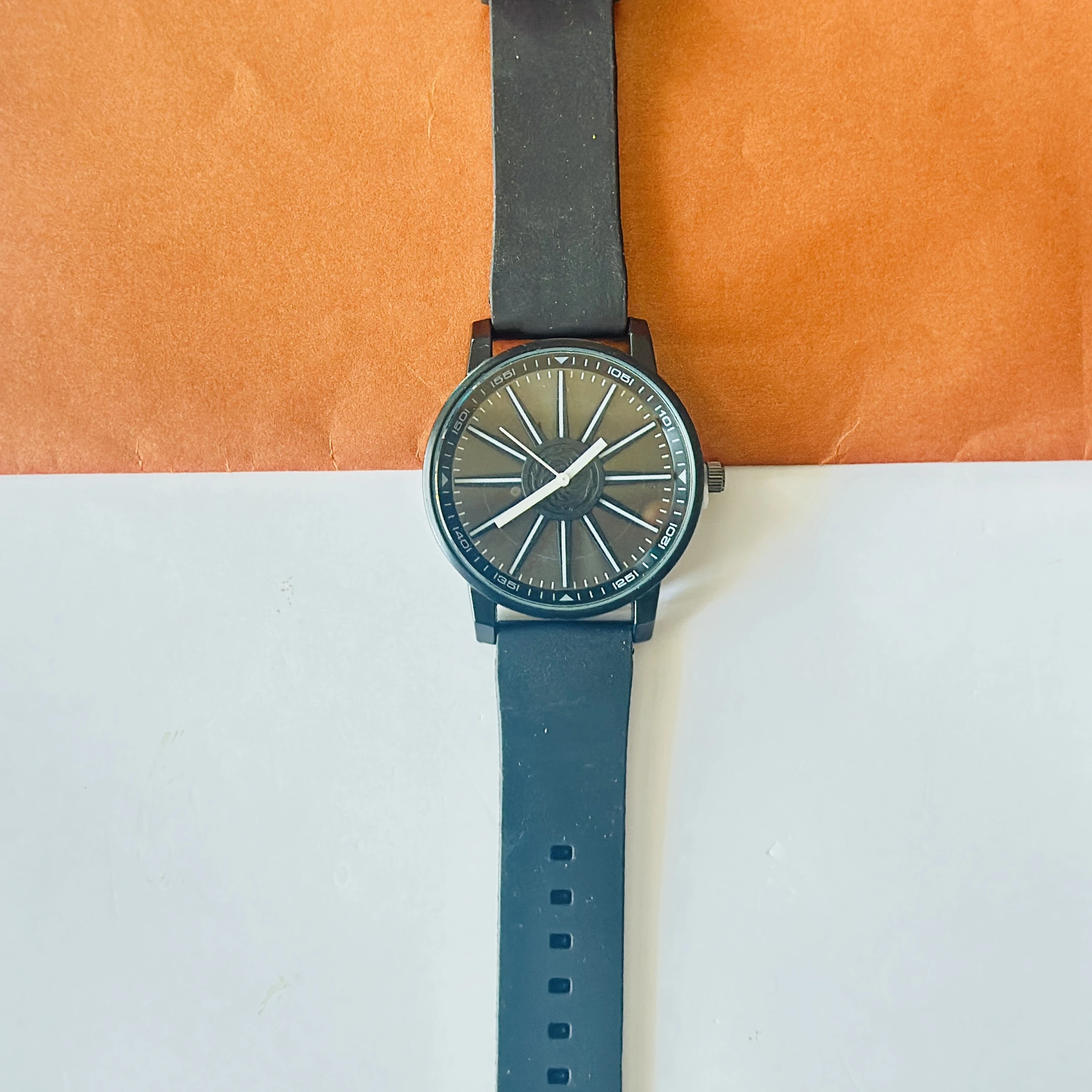 watch appears to be a V9 Collection black analog wristwatch with a silicone strap.