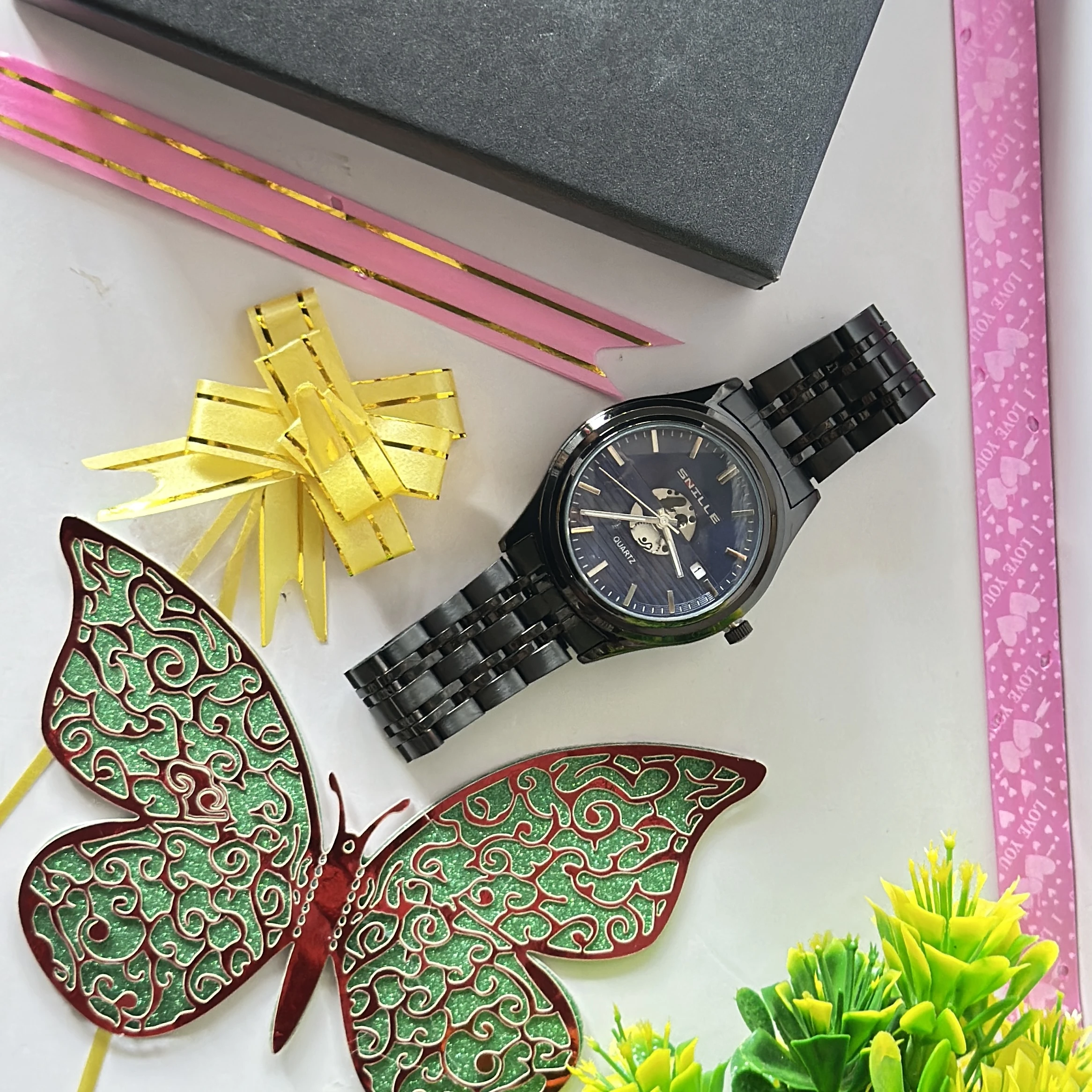 Snille brand wristwatch features a black analog