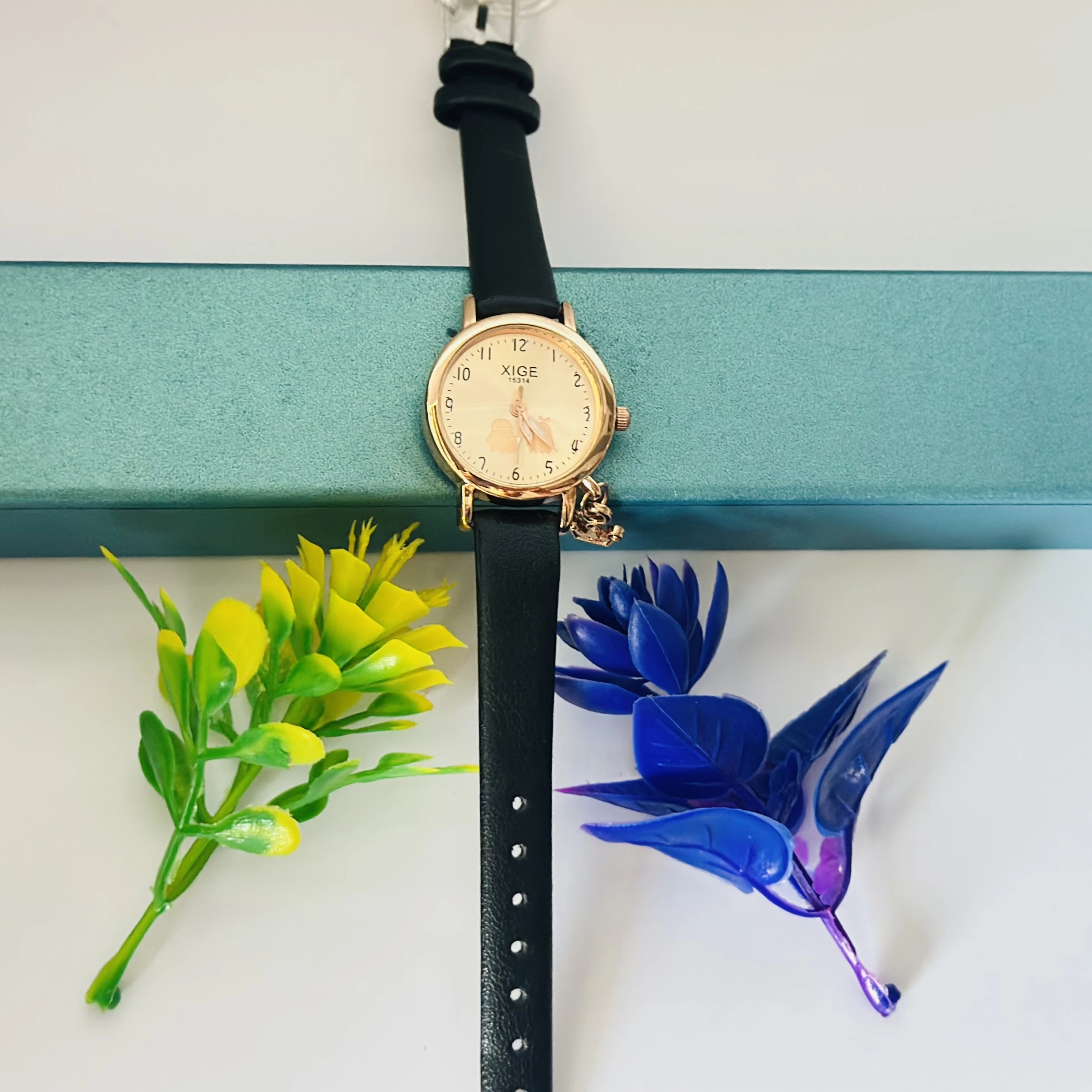 Quartz watch with a black leather band and a rose gold-tone case.