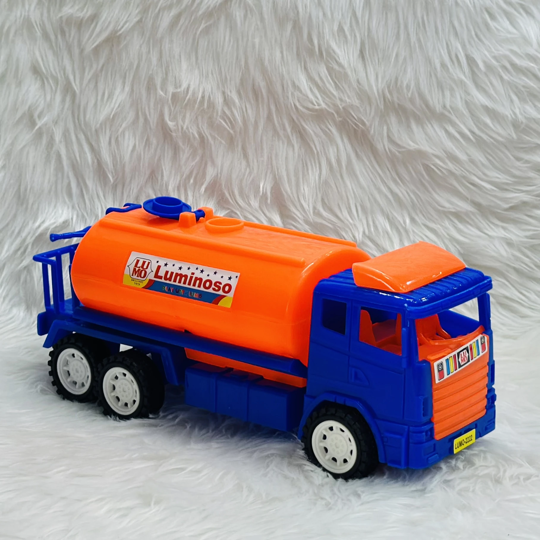 Luminoso brand friction-powered oil tanker truck toy.