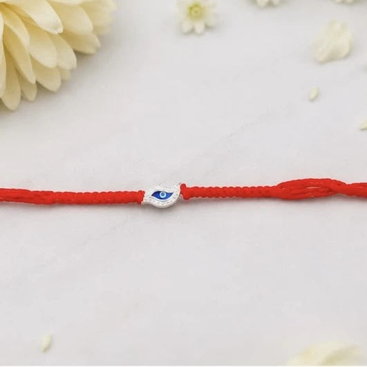 Rakhi features a golden Om symbol on a hexagon charm.
