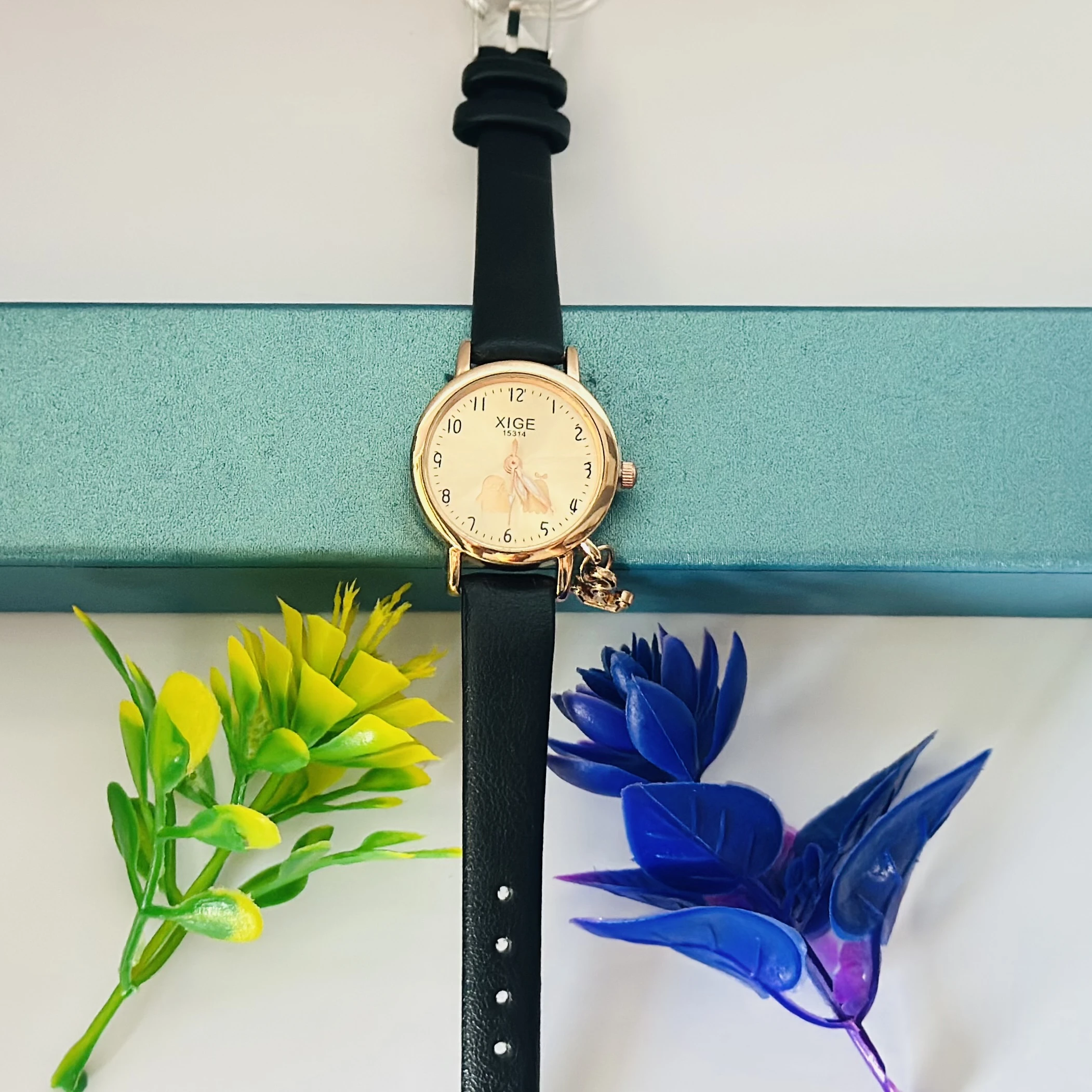Quartz watch with a black leather band and a rose gold-tone case.