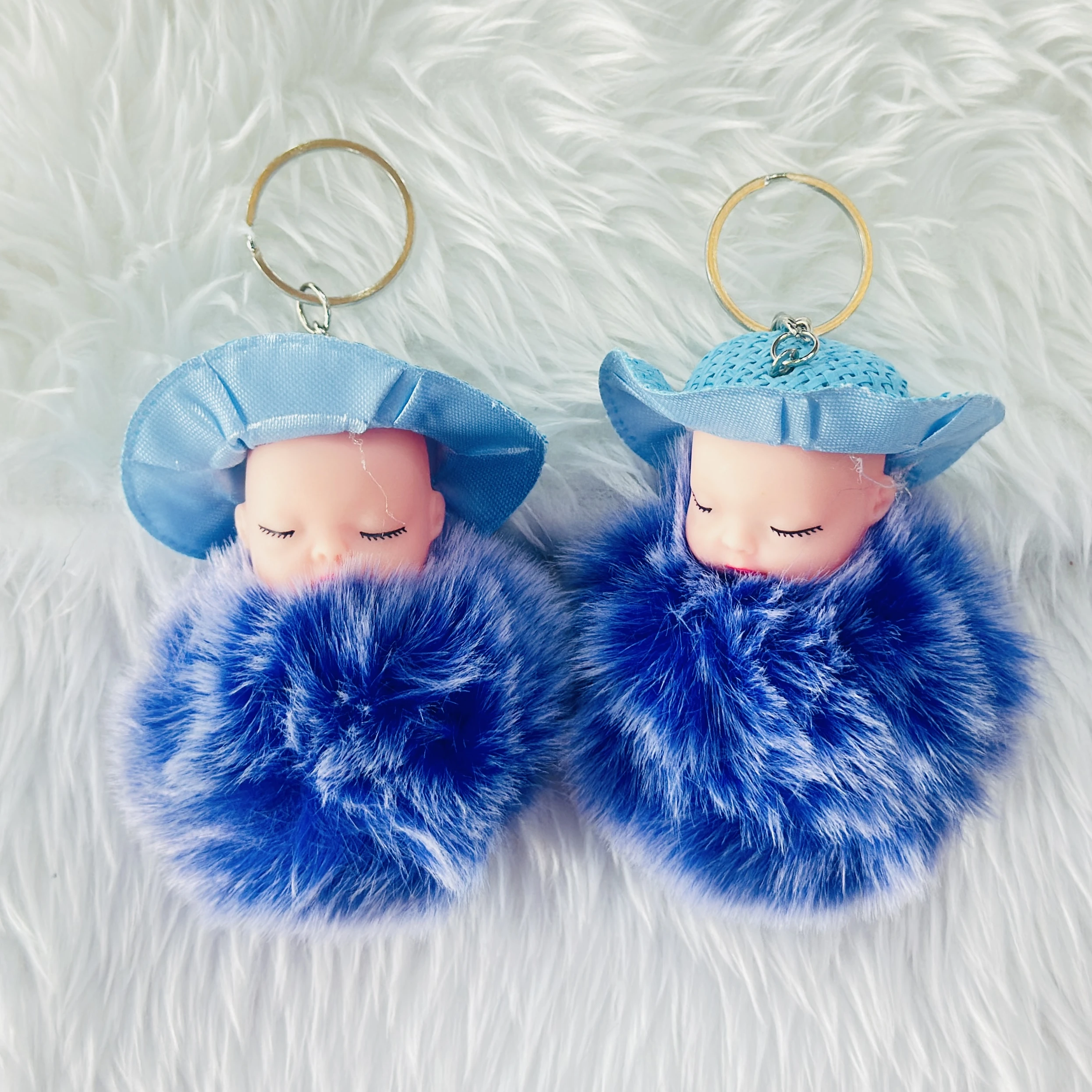 fluffy charm is a red and white SRG sleeping baby doll keychain