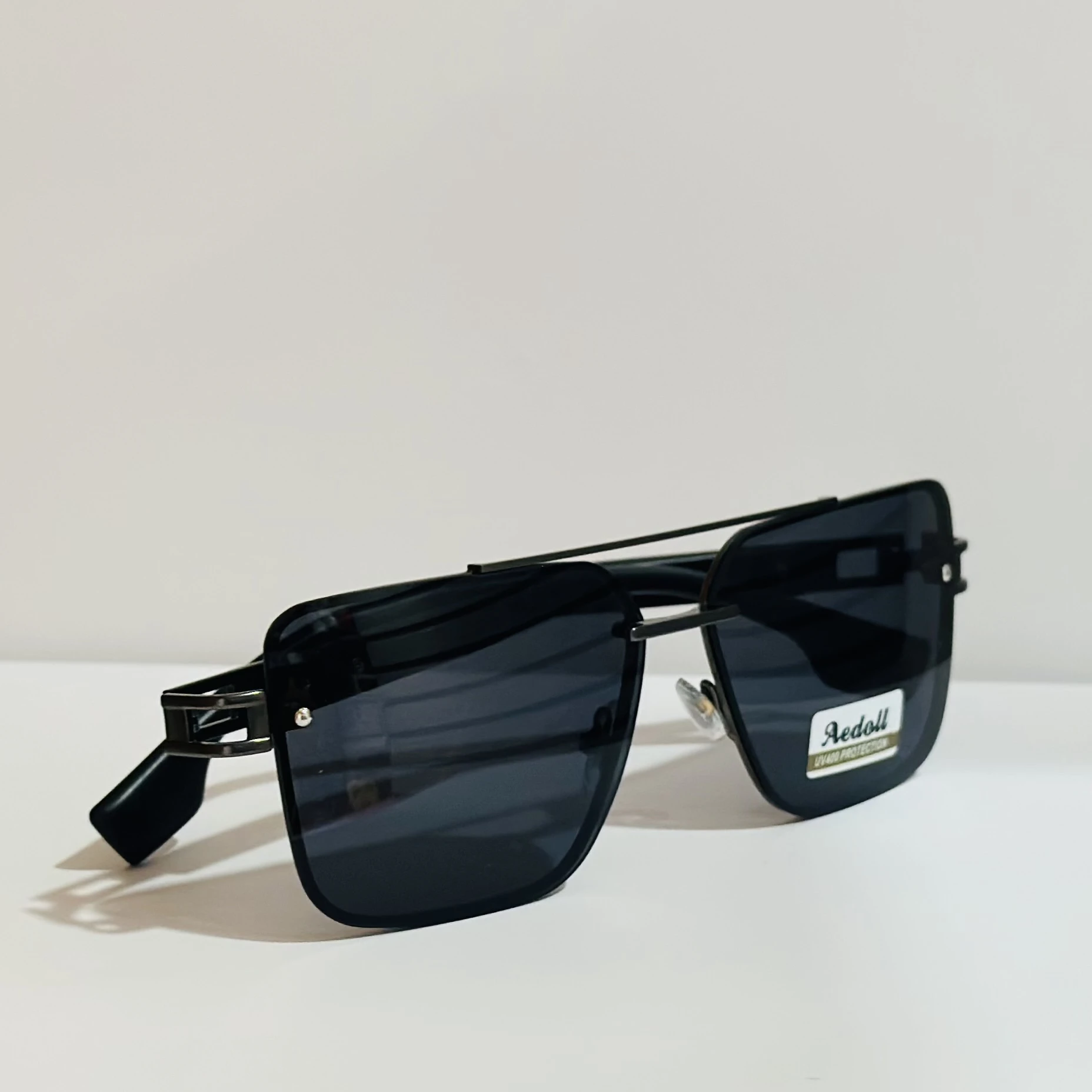 pair of square aviator sunglasses with a black metal frame and gradient lenses.