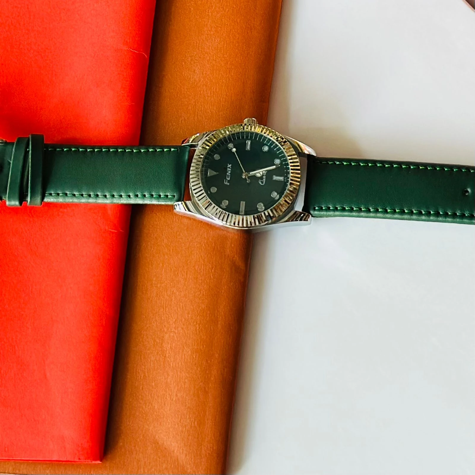 Round analog watch with a Green  leather strap