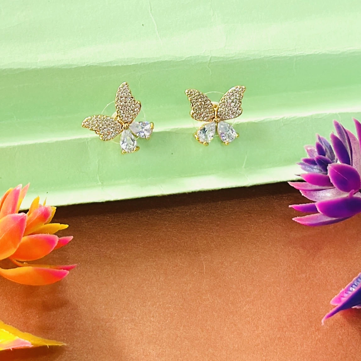 Gold toned, butterfly-shaped stud earrings