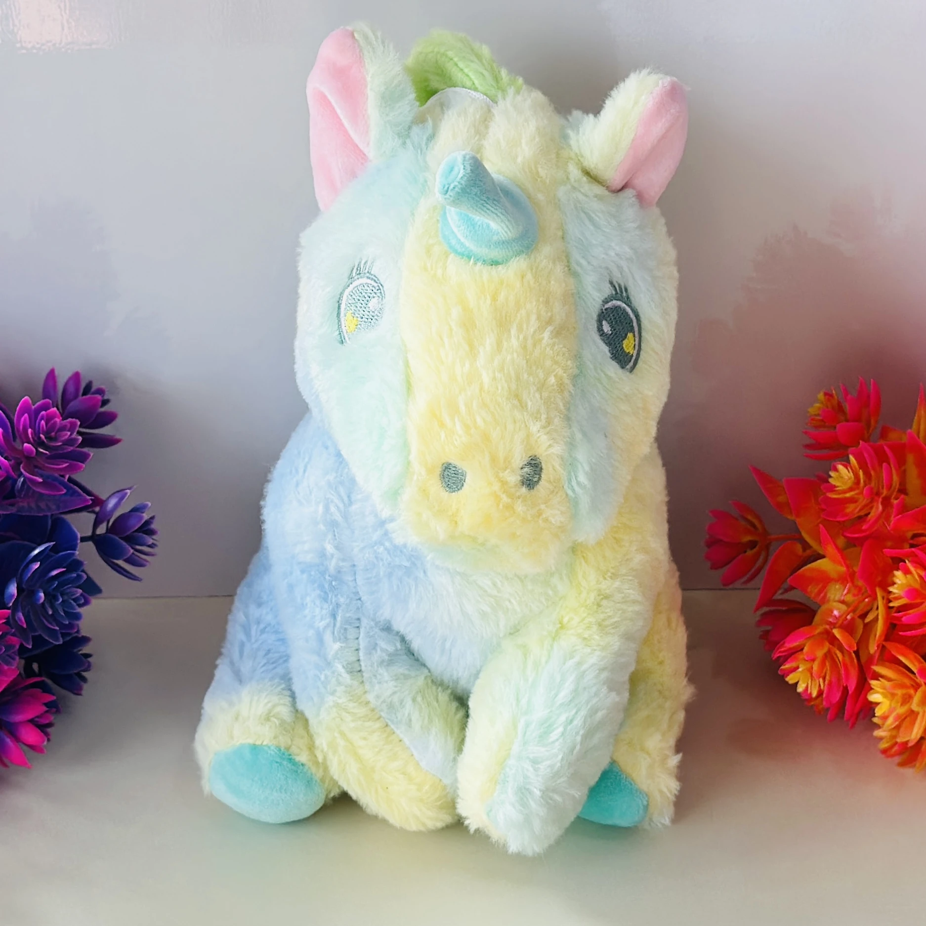 pastel rainbow-colored unicorn soft toy