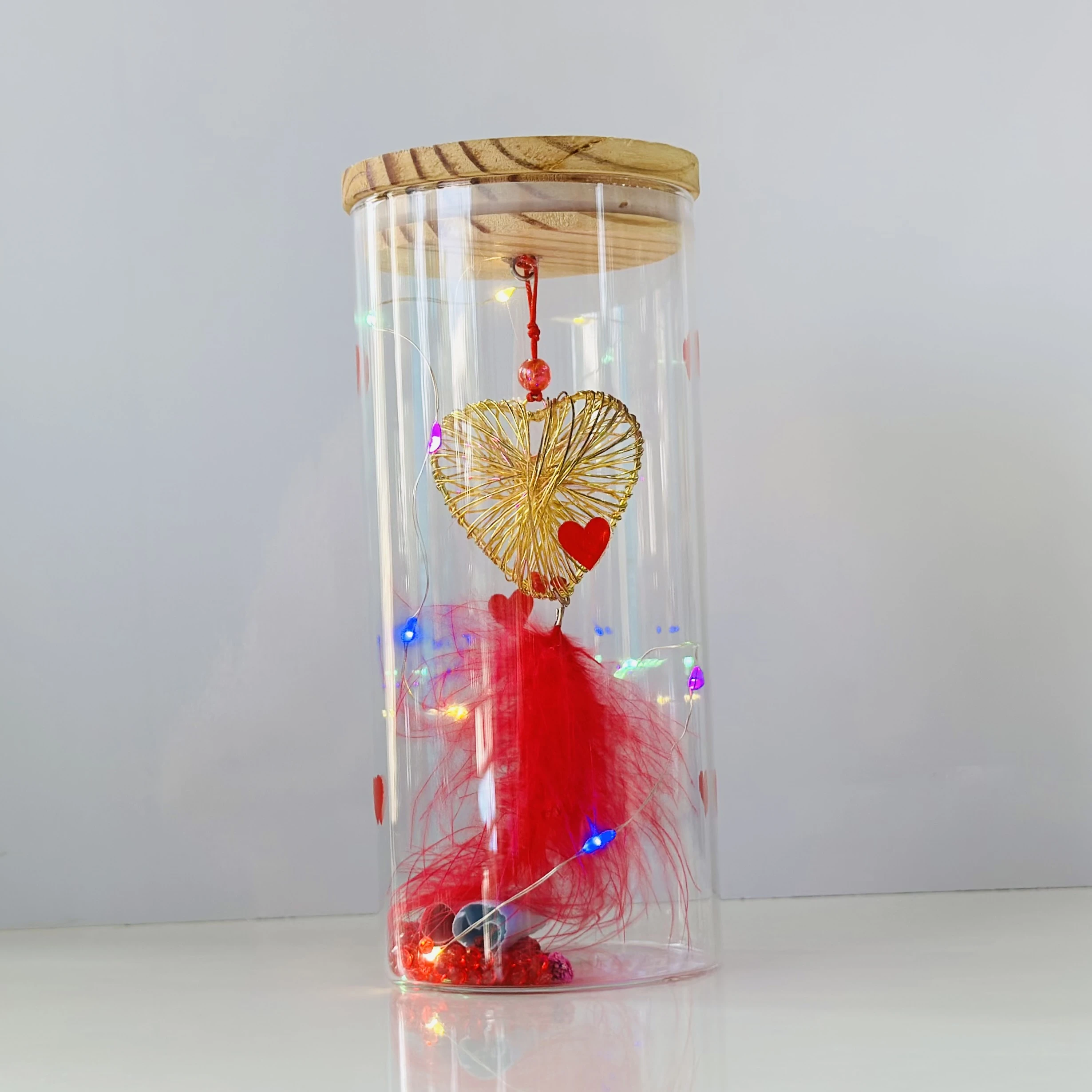 glass light with a wire heart, red feathers, and LED fairy lights. (SKU-86EZEW)