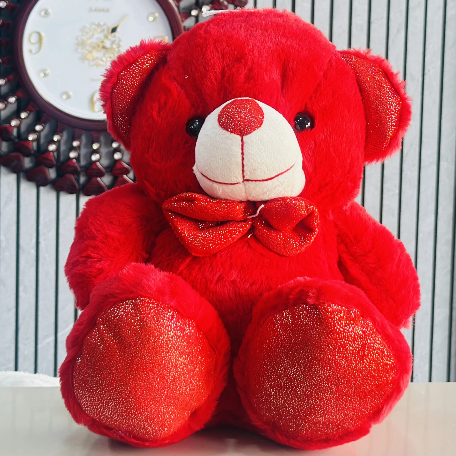 Red plush teddy bear, a type of soft toy.