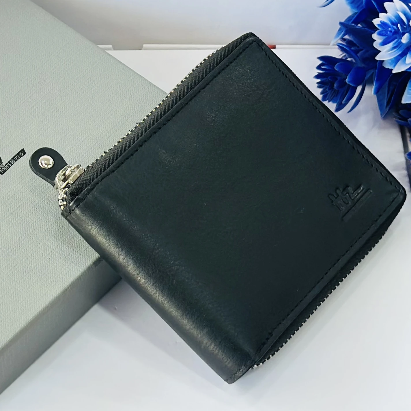 Black HZ leather zip-around wallet for men.