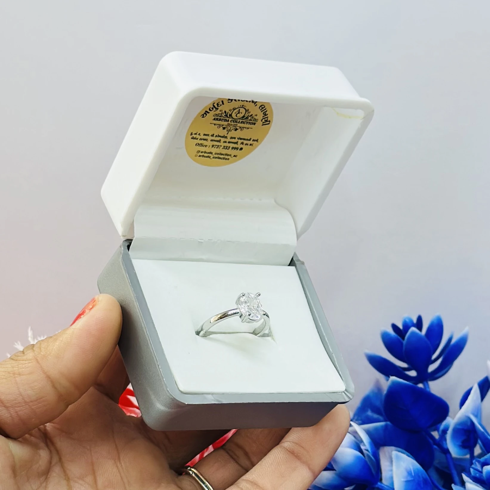 silver solitaire ring with a moissanite stone.