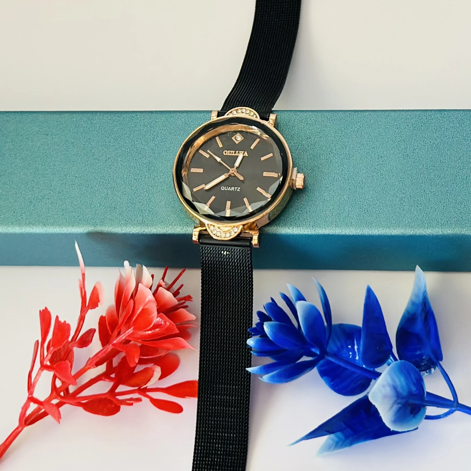 women's black mesh watch with a rose gold-tone case and a crystal accent.