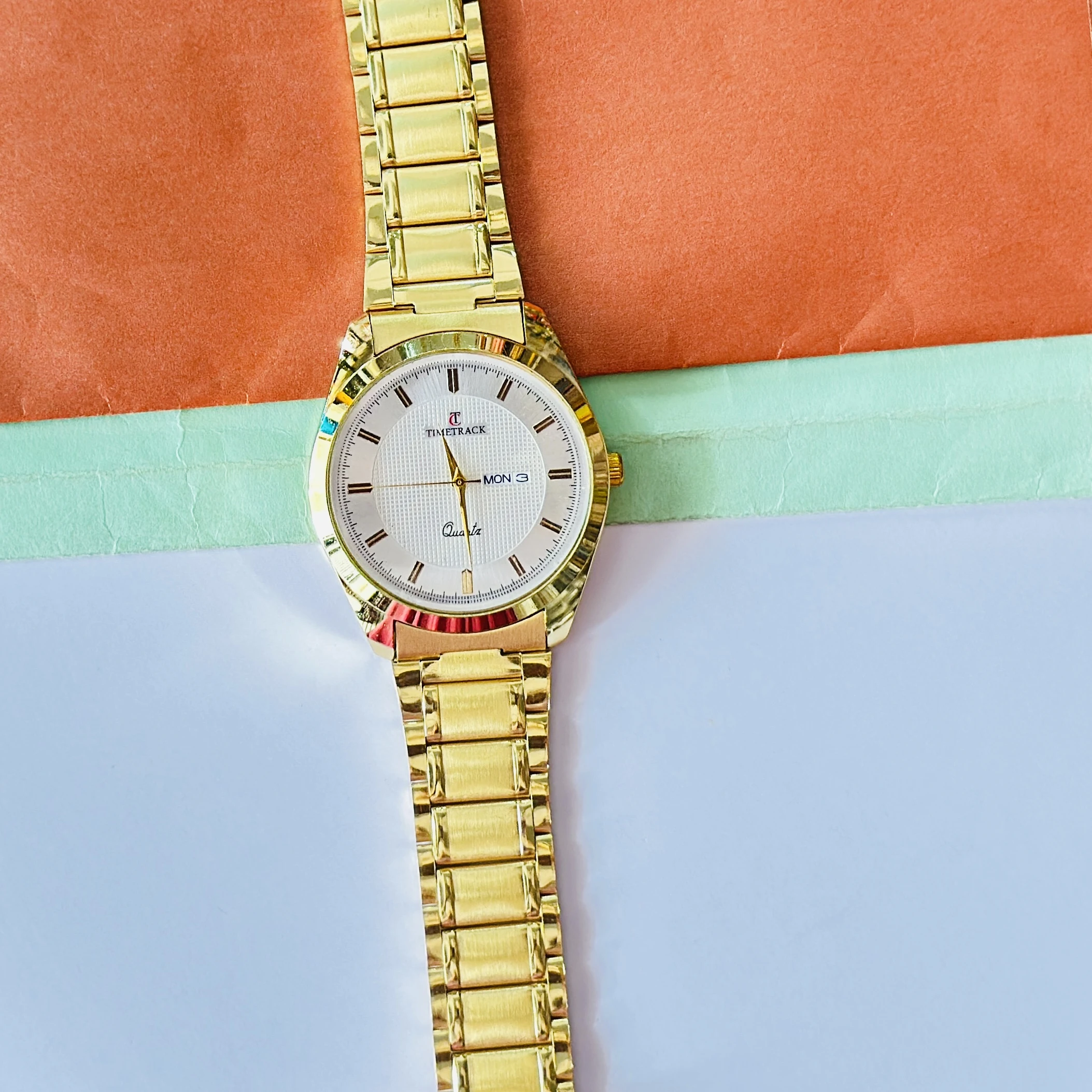 Gold coloured analogue watch