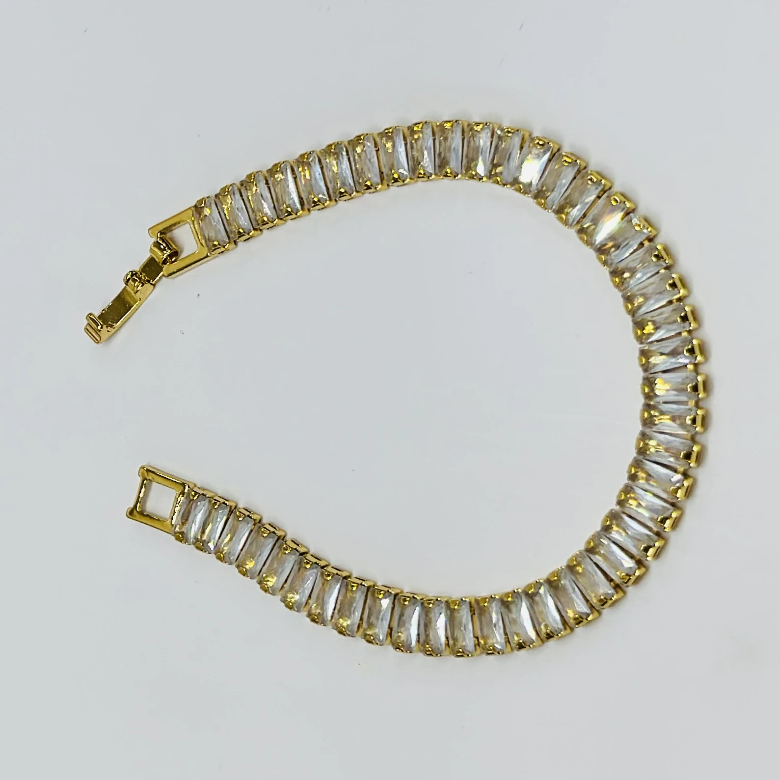 Gold plated black baguette tennis bracelet with artificial stones.