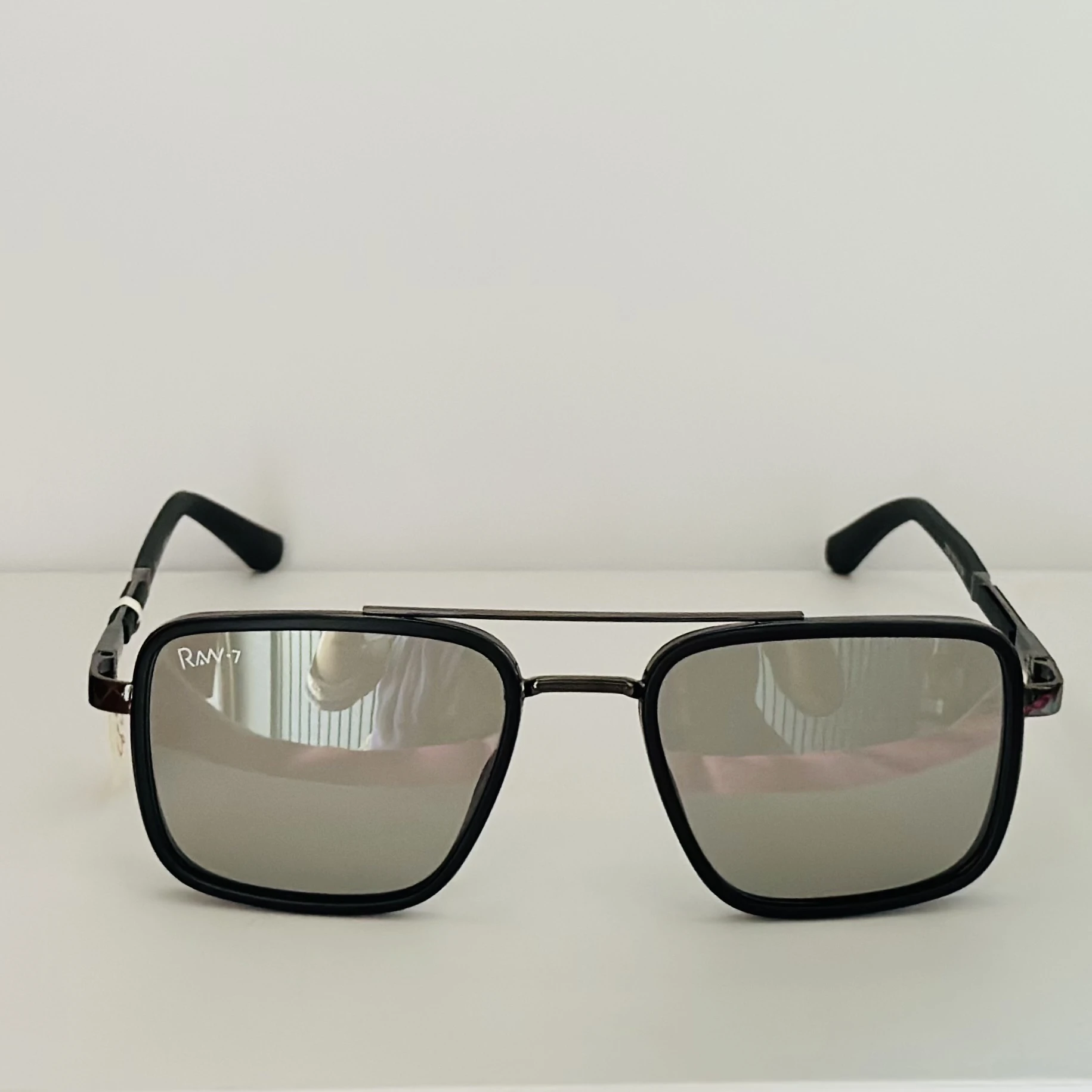 RAW-7 aviator sunglasses with a black frame and silver lenses.