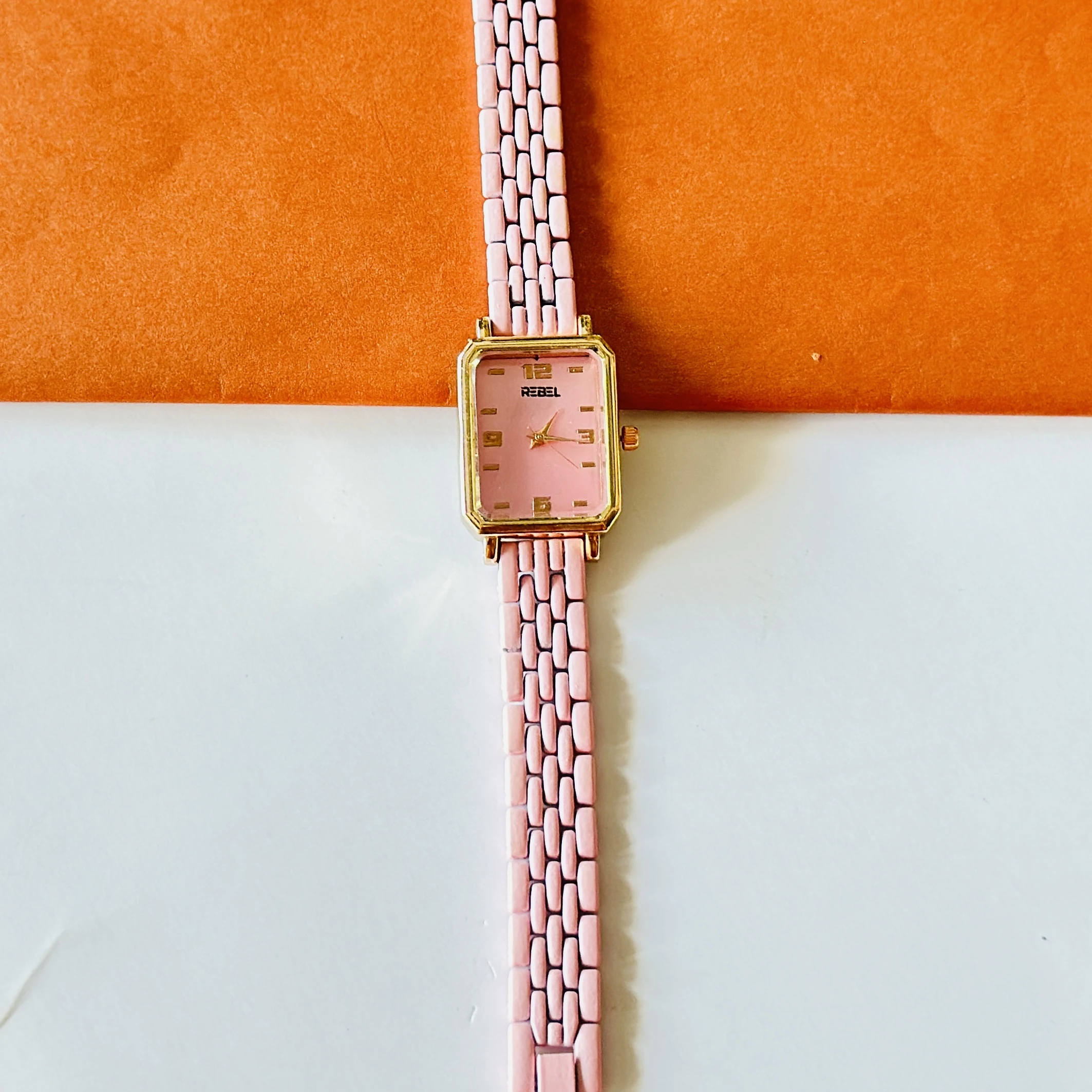 Rebel quartz watch with a pink dial and matching strap.